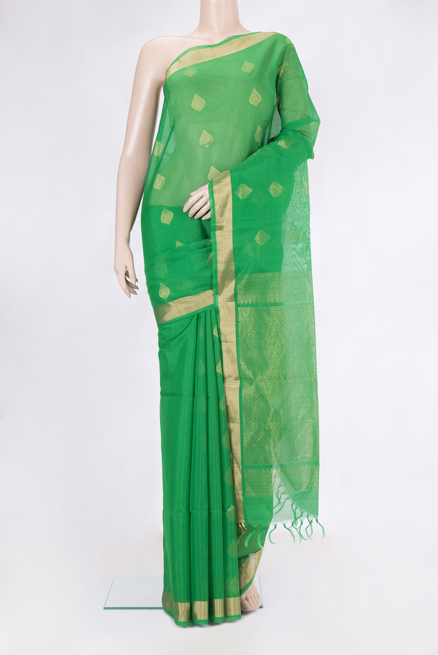 Green Silk Cotton Saree with Zari Butta on the body and Zari Border.  displayed on a mannequin