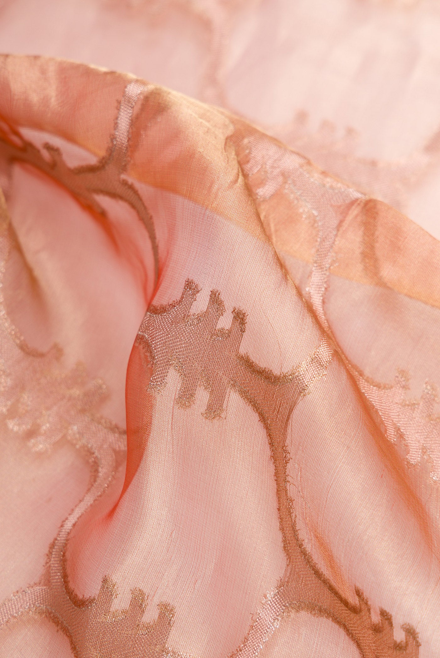 Close up of Coral Dual Tone Organza Silk Saree with Zari Brocade on the body and Zari Border.  displaying folds