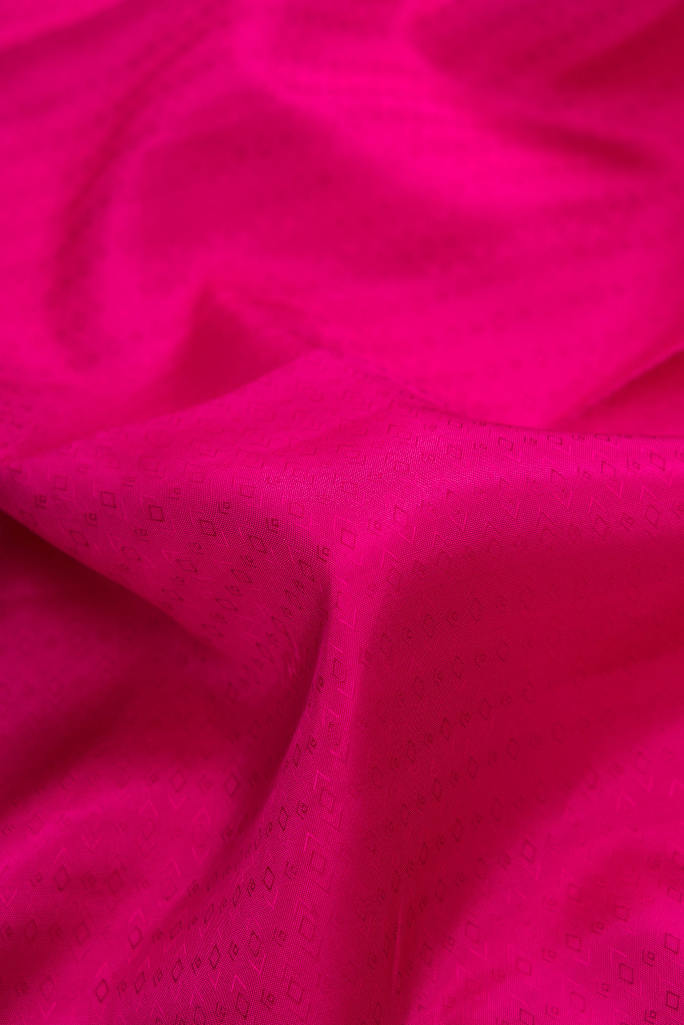 Close up of Pink Dual Tone Kanjivaram Silk Saree with Jacquard design on the body and Zari Border.  displaying folds
