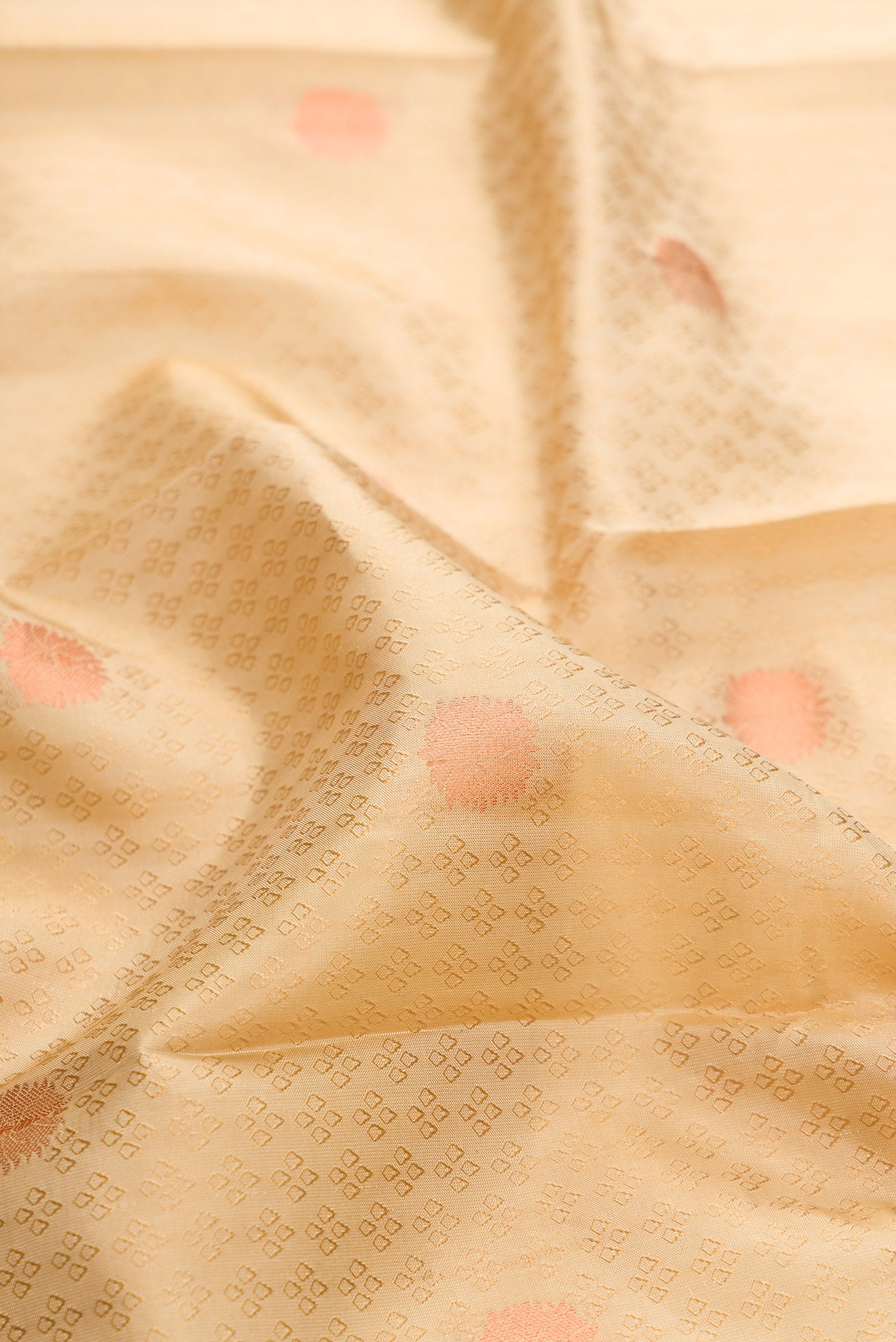 Close up of Beige Dual Tone Kanchipuram Silk Saree with Jacquard With Zari Butta on the body and Zari Border.  displaying folds