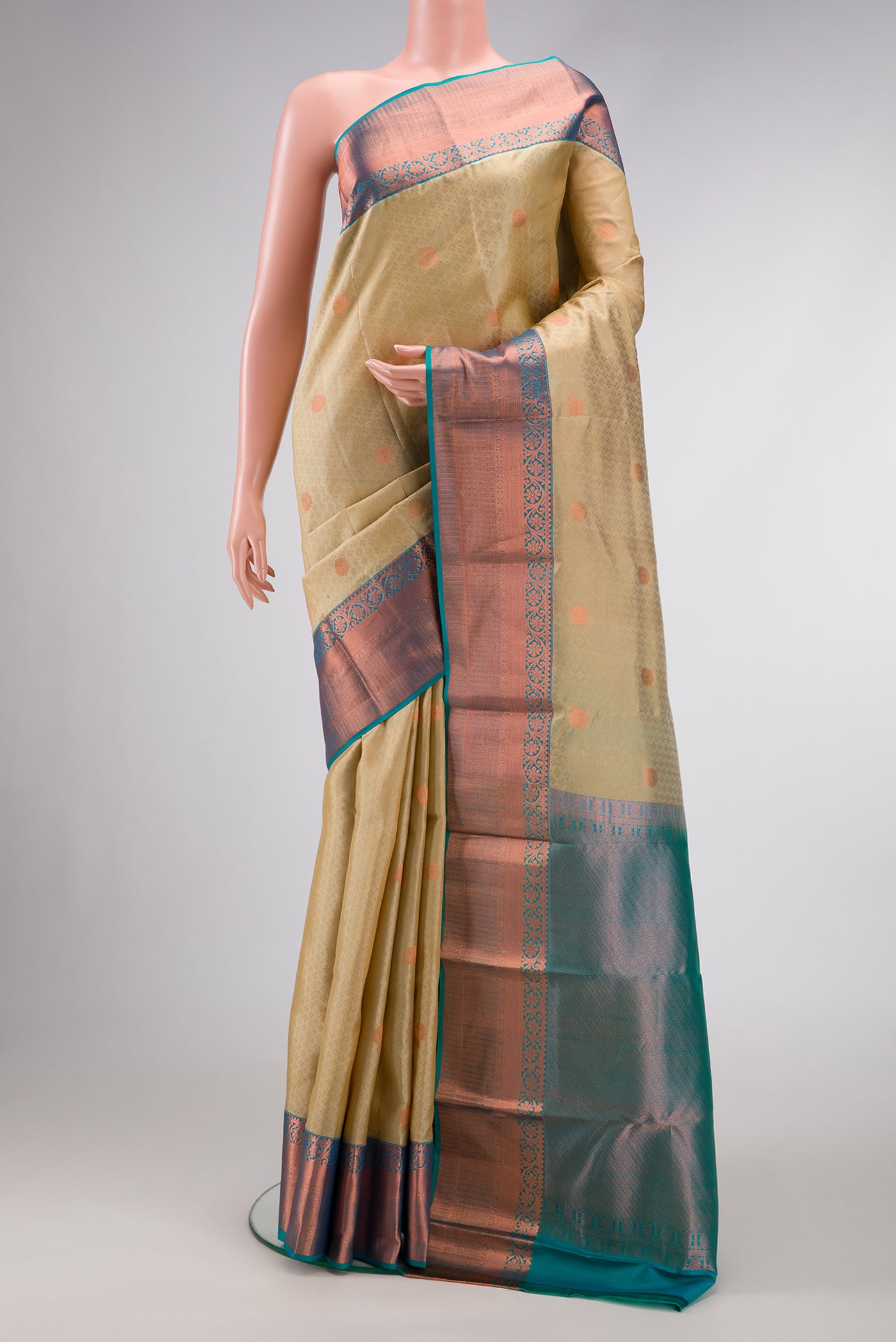 Beige Dual Tone Kanchipuram Silk Saree with Jacquard With Zari Butta on the body and Zari Border.  displayed on a mannequin