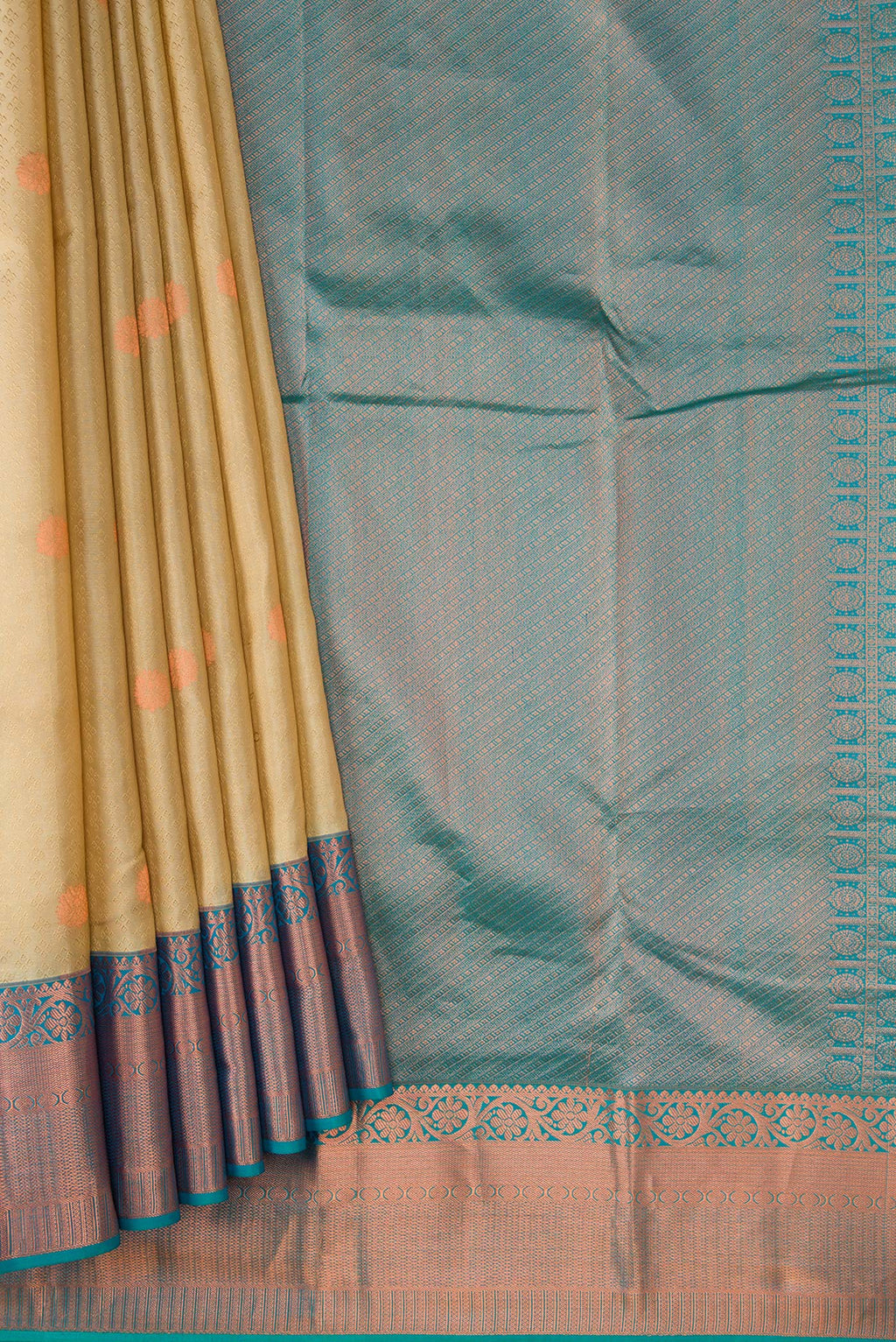 Pleats and pallu of Beige Dual Tone Kanchipuram Silk Saree with Jacquard With Zari Butta on the body and Zari Border. 
