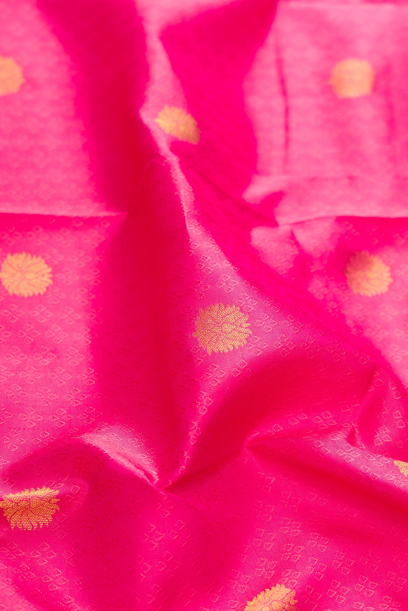 Close up of Pink Dual Tone Kanchipuram Silk Saree with Jacquard With Zari Butta on the body and Zari Border.  displaying folds
