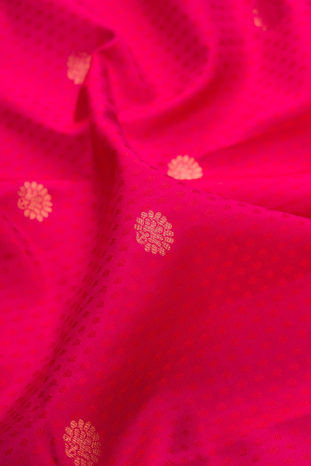 Close up of Pink Dual Tone Kanchipuram Silk Saree with Jacquard With Zari Butta on the body and Zari Border.  displaying folds