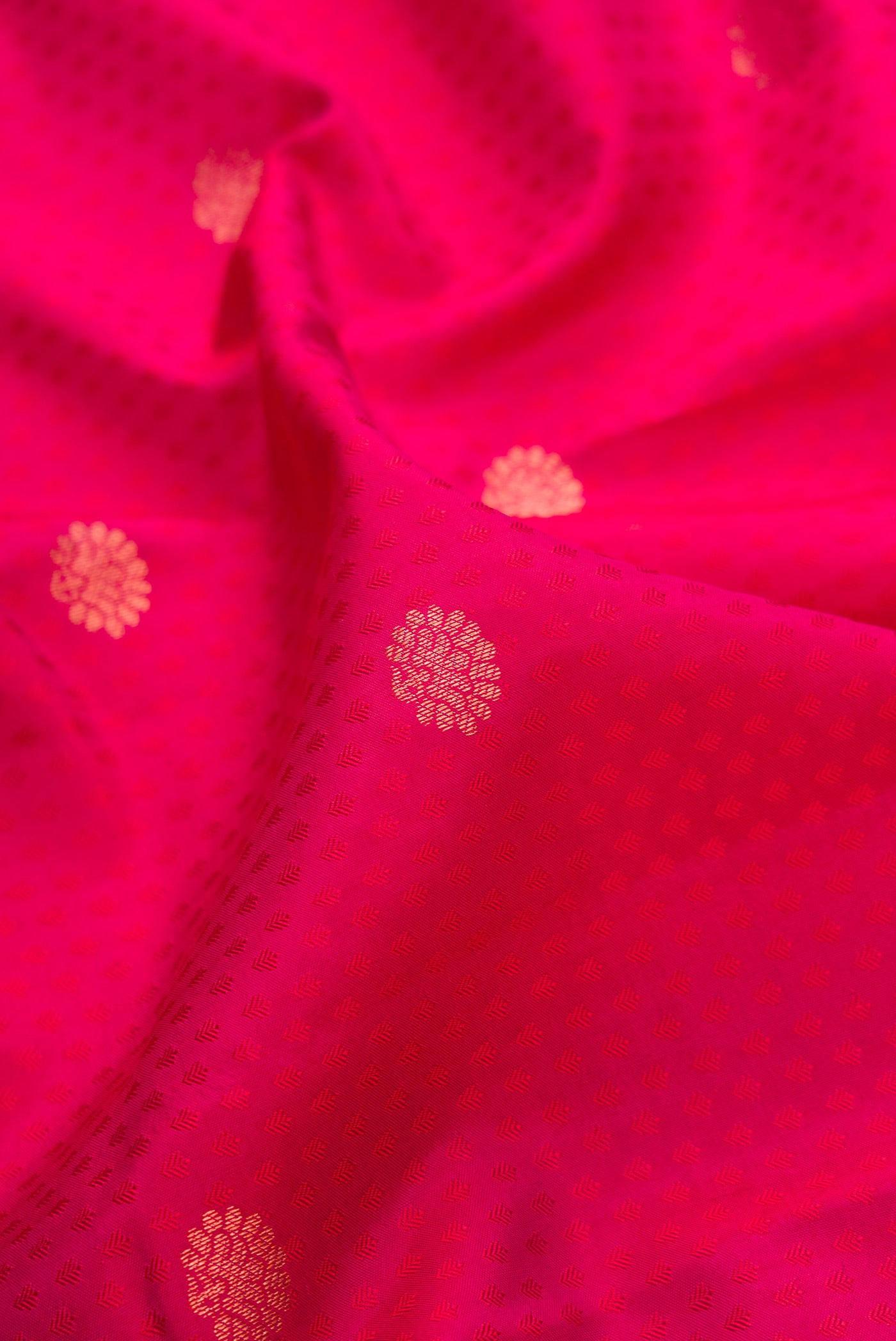 Close up of Pink Dual Tone Kanchipuram Silk Saree with Jacquard With Zari Butta on the body and Zari Border.  displaying folds