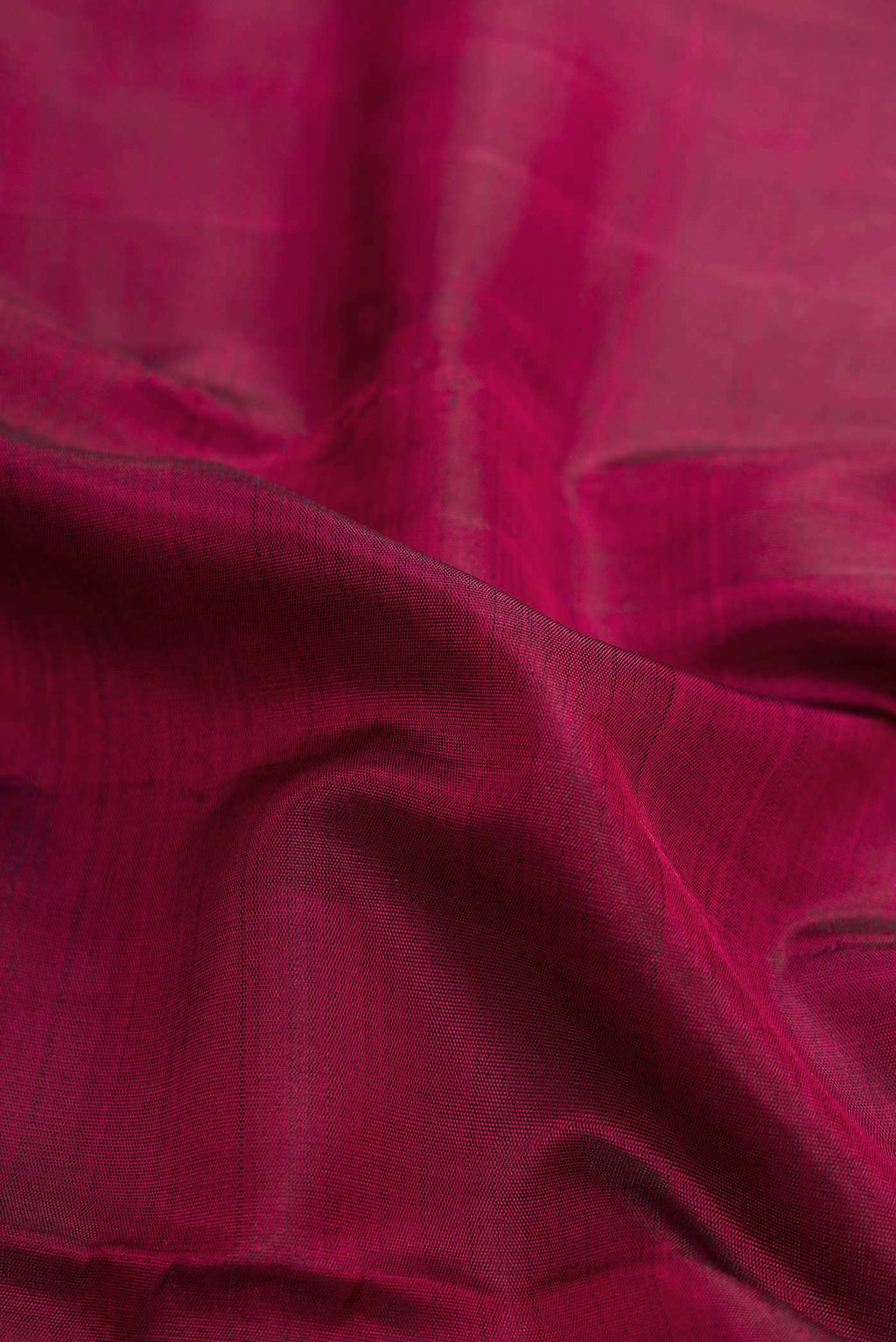 Close up of Maroon Dual Tone Kanjivaram Silk Saree with Plain Body and Zari Border.  displaying folds