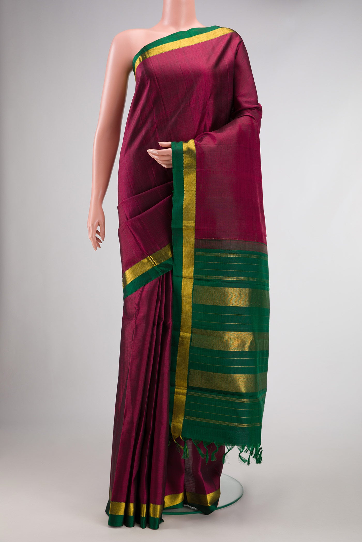Maroon Dual Tone Kanjivaram Silk Saree with Plain Body and Zari Border.  displayed on a mannequin