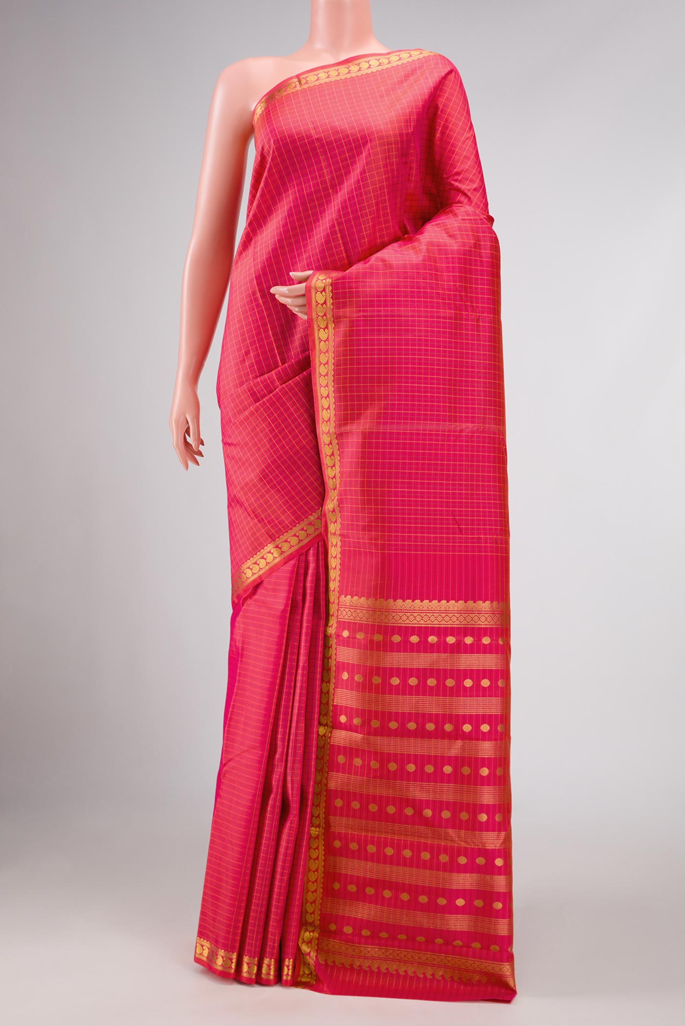 Coral Dual Tone Kanchipuram Silk Saree with Checked design on the body and Zari Border displayed on a mannequin