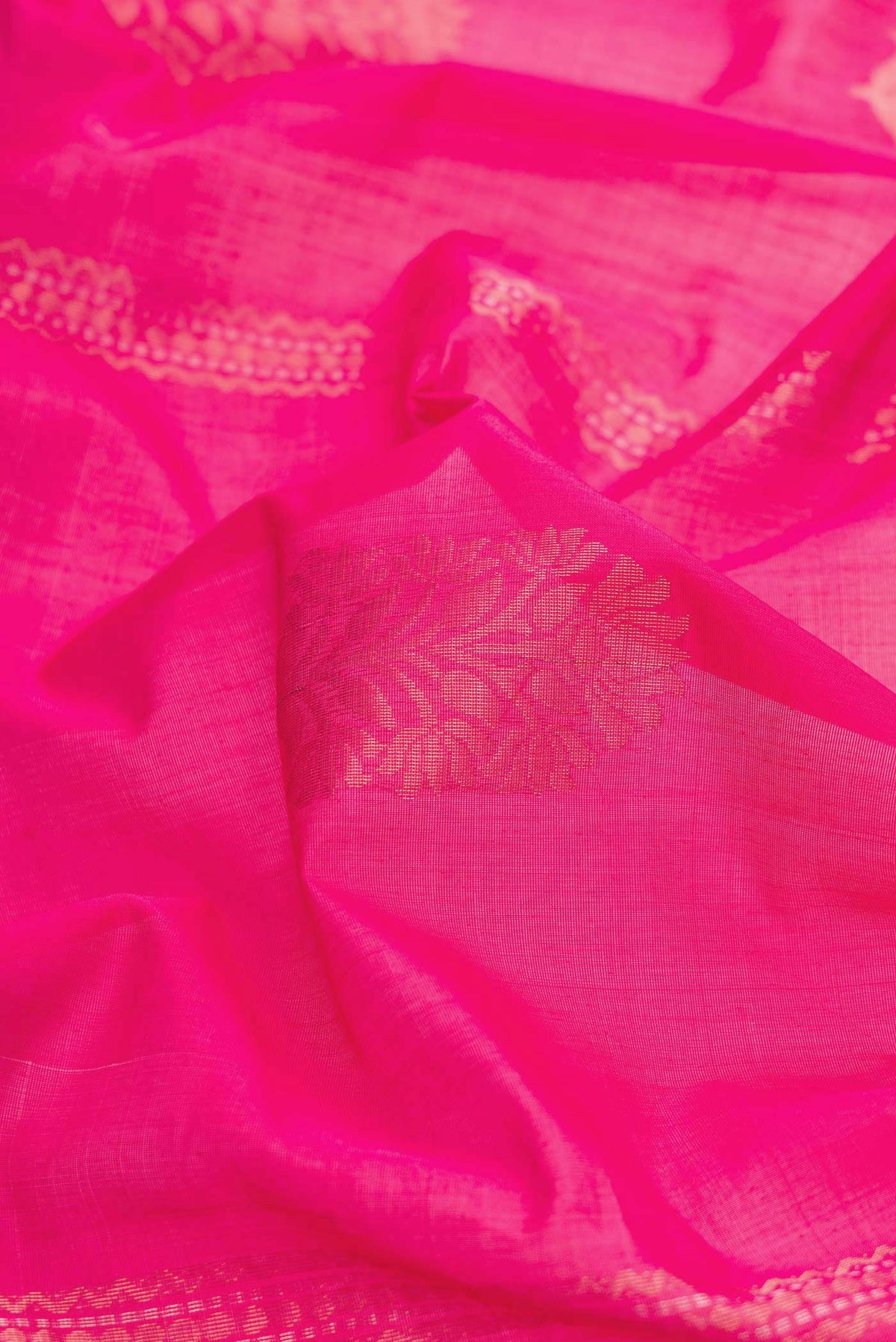 Close up of Pink Dual Tone Silk Cotton Saree with Zari Butta on the body and Zari Border displaying folds