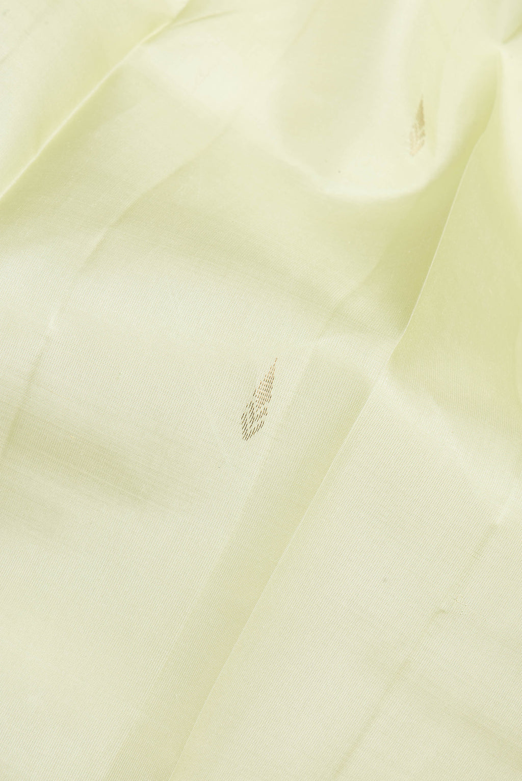 Close up of Pure Silk Light Green Kanjivaram Saree with Zari Butta on the body and Fancy Border.  displaying folds