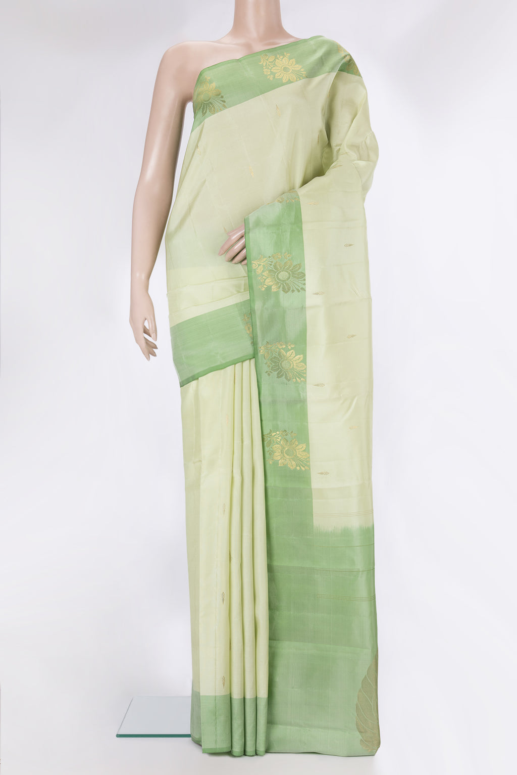 Pure Silk Light Green Kanjivaram Saree with Zari Butta on the body and Fancy Border.  displayed on a mannequin