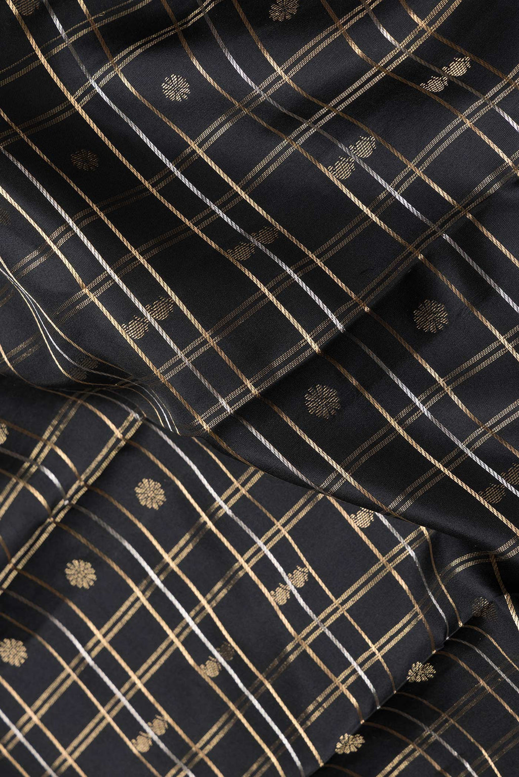 Close up of Black Dual Tone Kanchipuram Silk Saree with Checked design on the body and Zari Border.  displaying folds