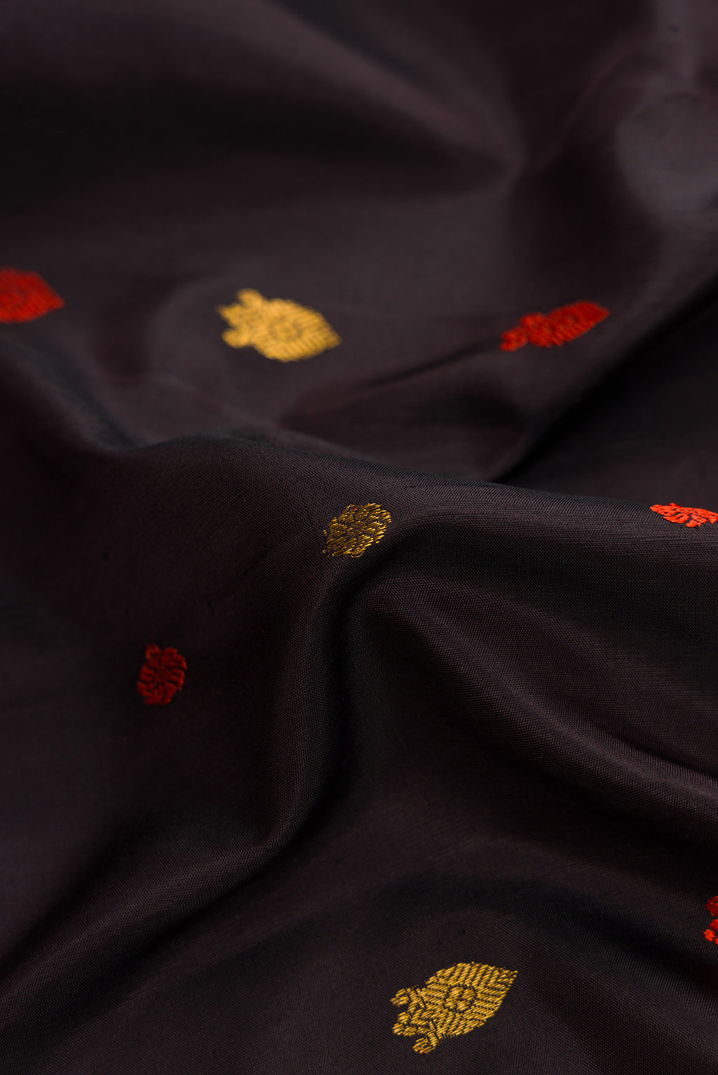 Close up of Black Dual Tone Gadwal Silk Saree with Zari And Thread Butta on the body and Zari Border.  displaying folds