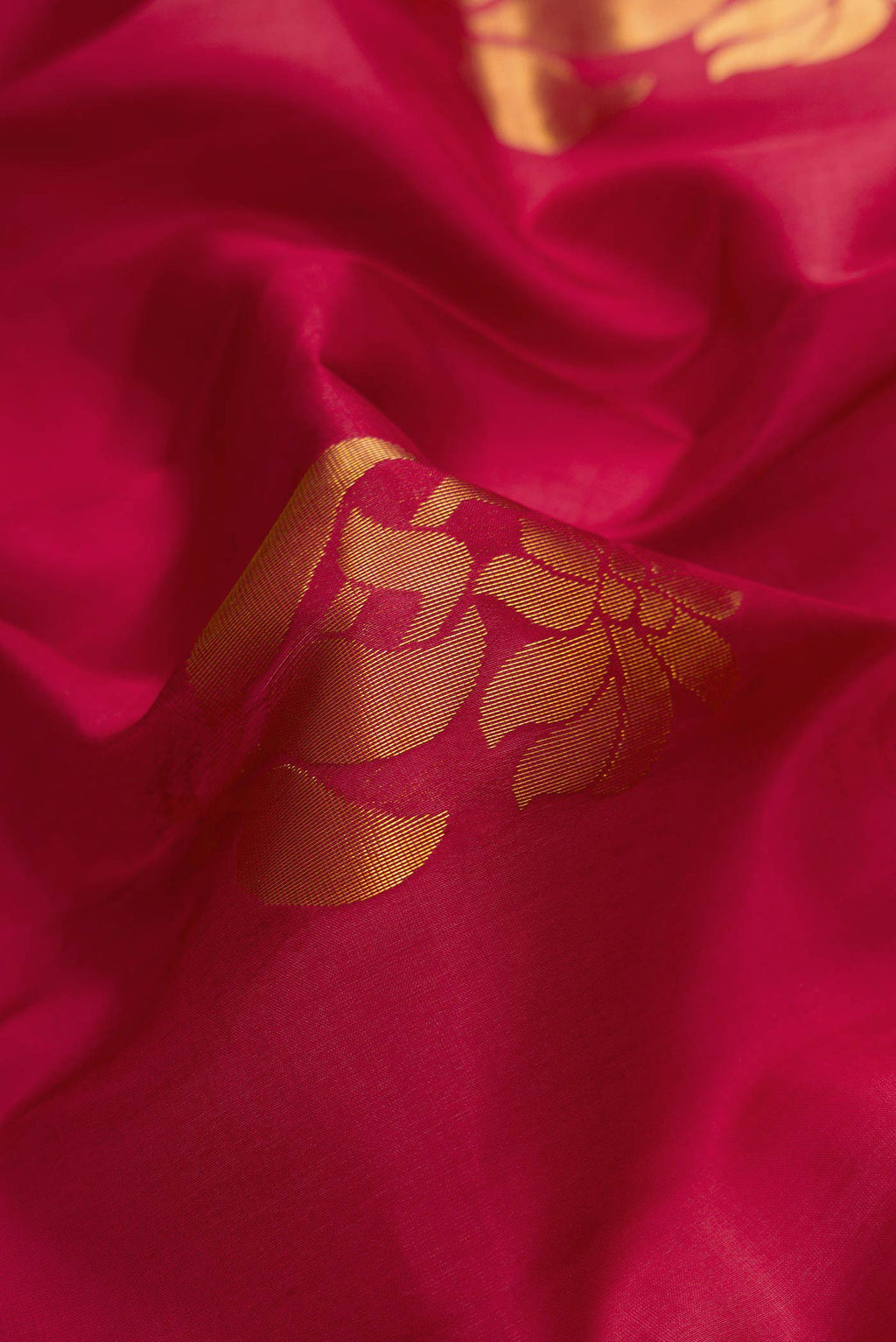 Close up of Maroon Dual Tone Soft Silk Saree with Zari Butta on the body and Zari Border.  displaying folds