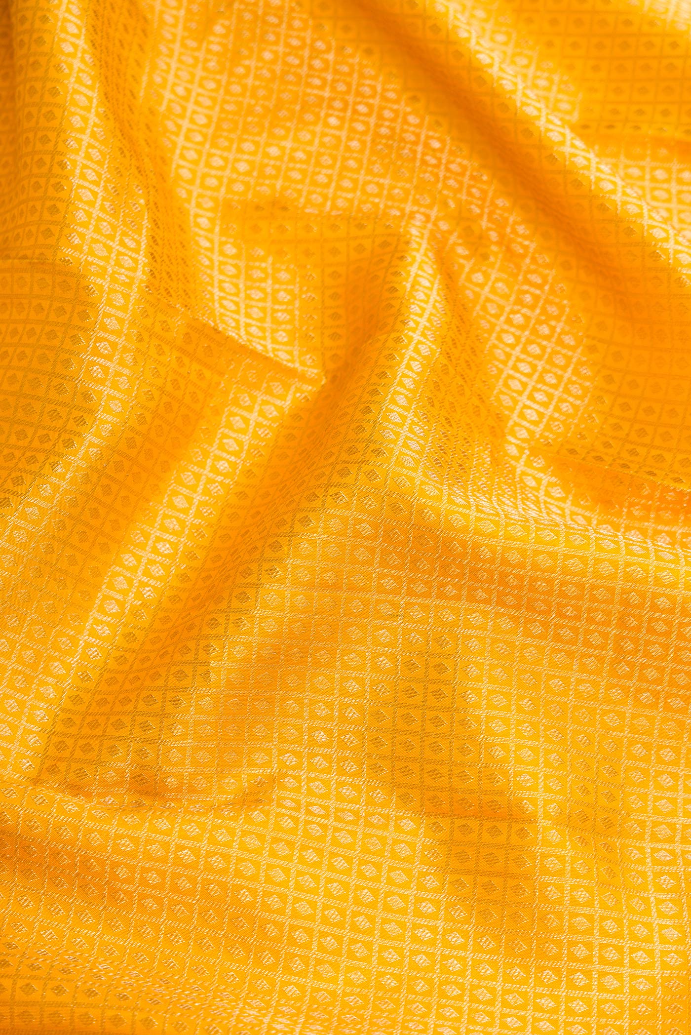 Close up of Mustard Dual Tone Kanjivaram Silk Saree with Zari Brocade on the body and Zari Border.  displaying folds