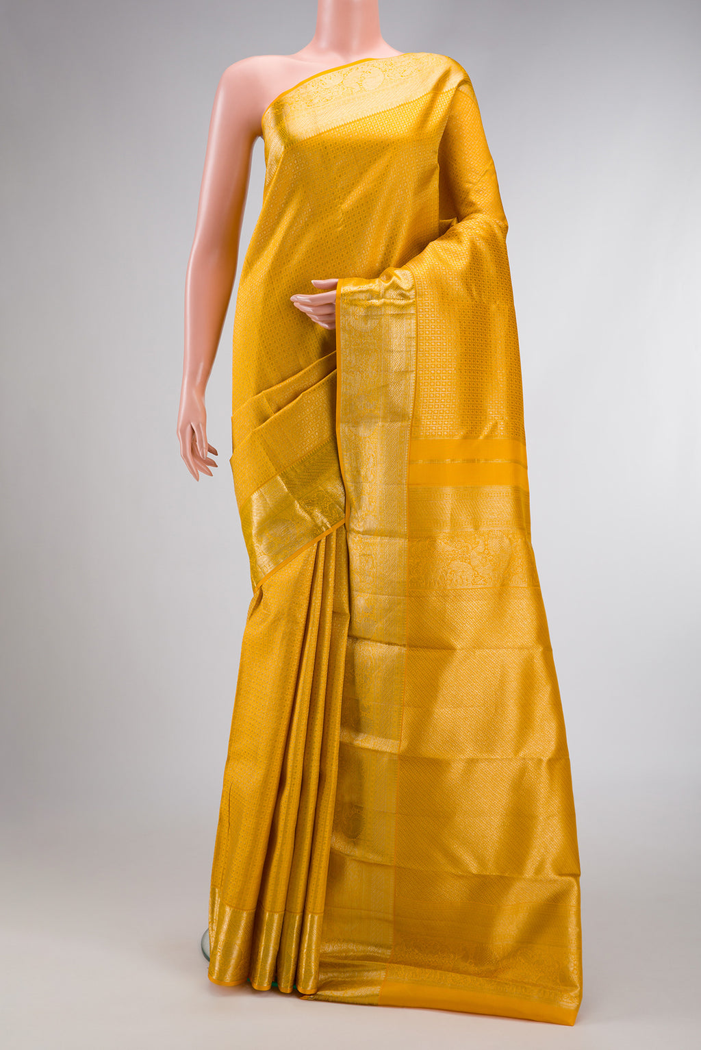 Mustard Dual Tone Kanjivaram Silk Saree with Zari Brocade on the body and Zari Border.  displayed on a mannequin