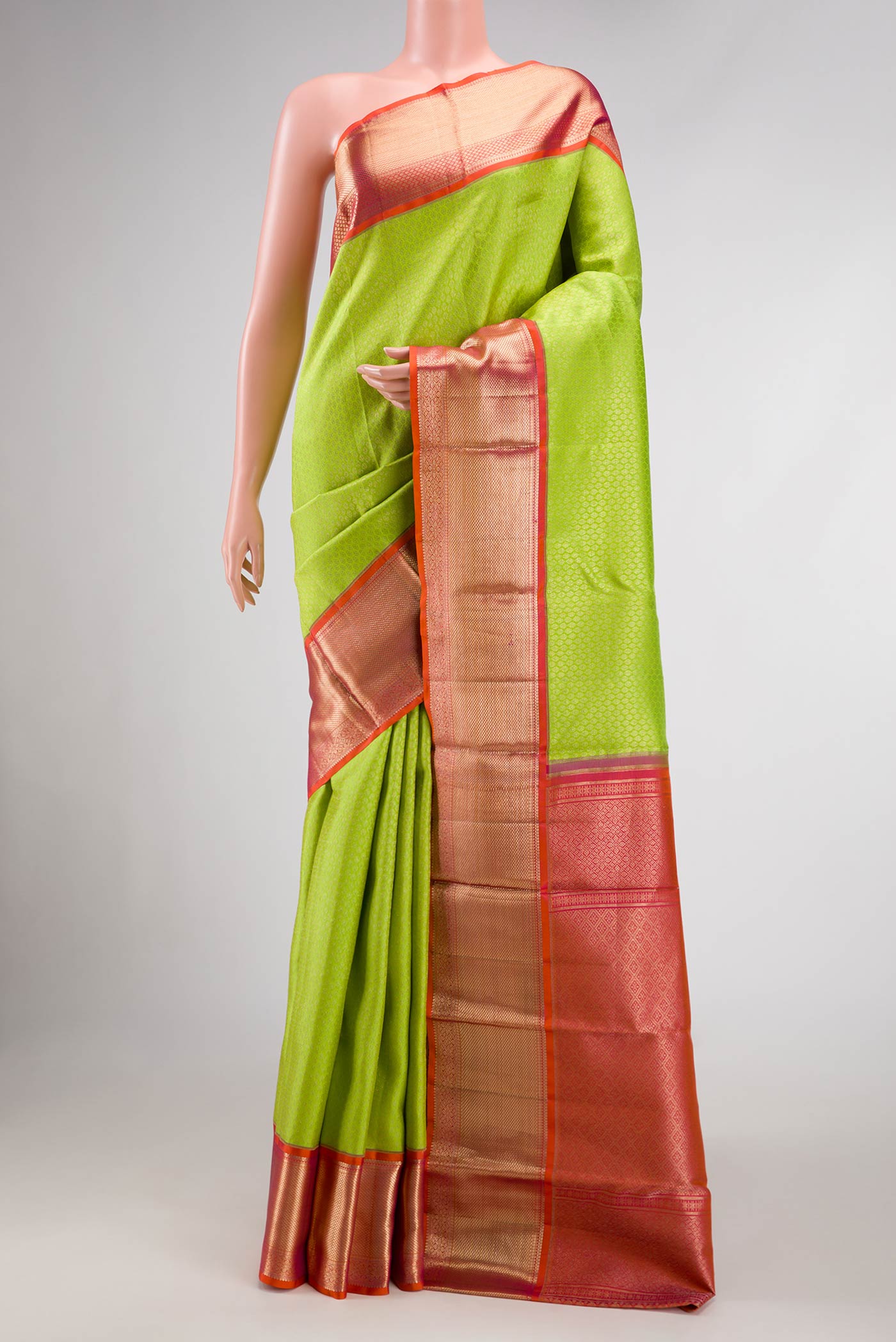Green Dual Tone Kanchipuram Silk Saree with Zari Brocade on the body and Zari Border.  displayed on a mannequin
