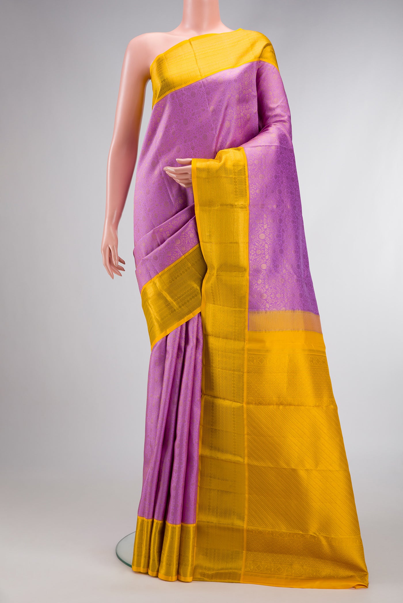 Lavender Dual Tone Kanchipuram Silk Saree with Zari Brocade on the body and Zari Border.  displayed on a mannequin