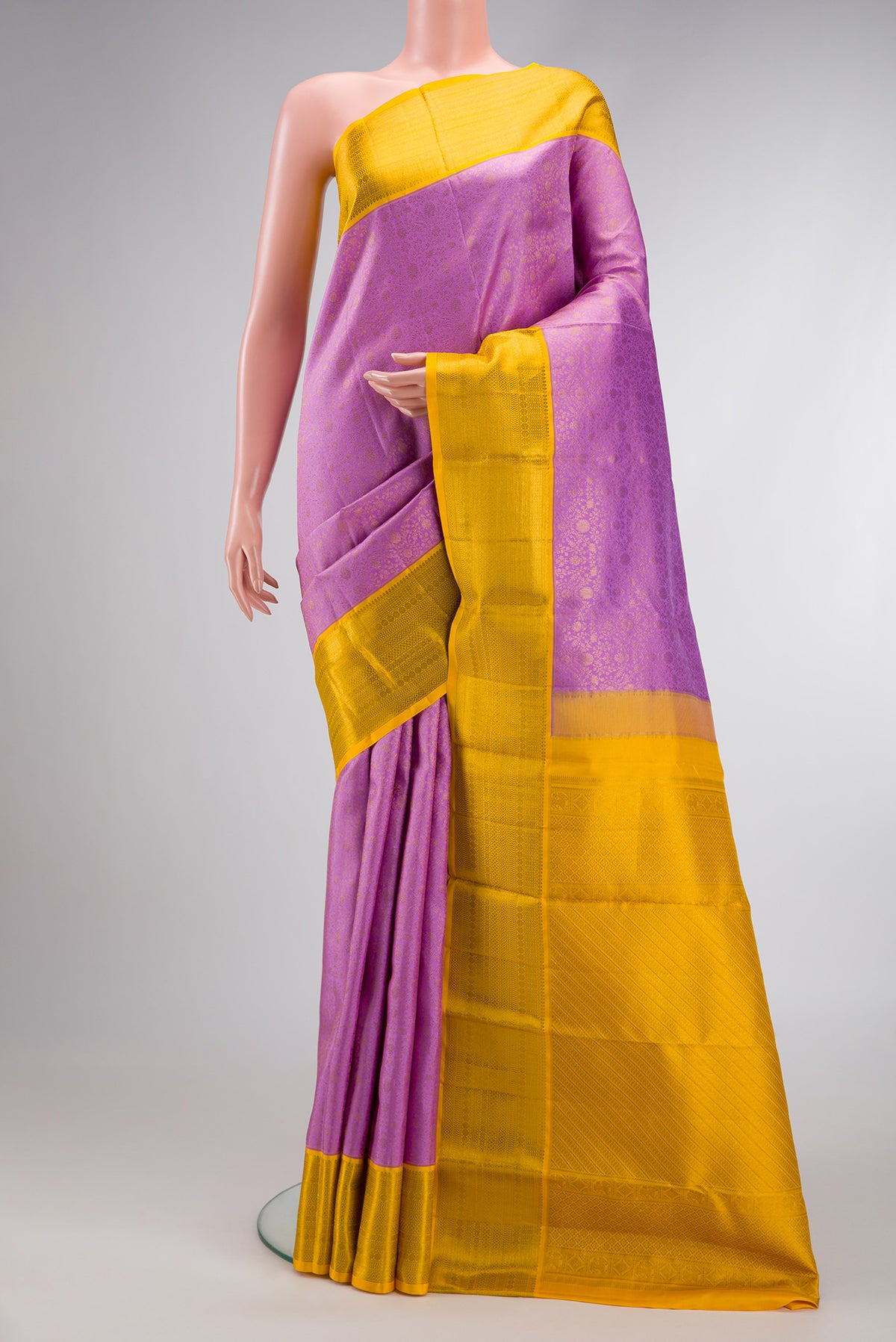 Lavender Dual Tone Kanchipuram Silk Saree with Zari Brocade on the body and Zari Border.  displayed on a mannequin
