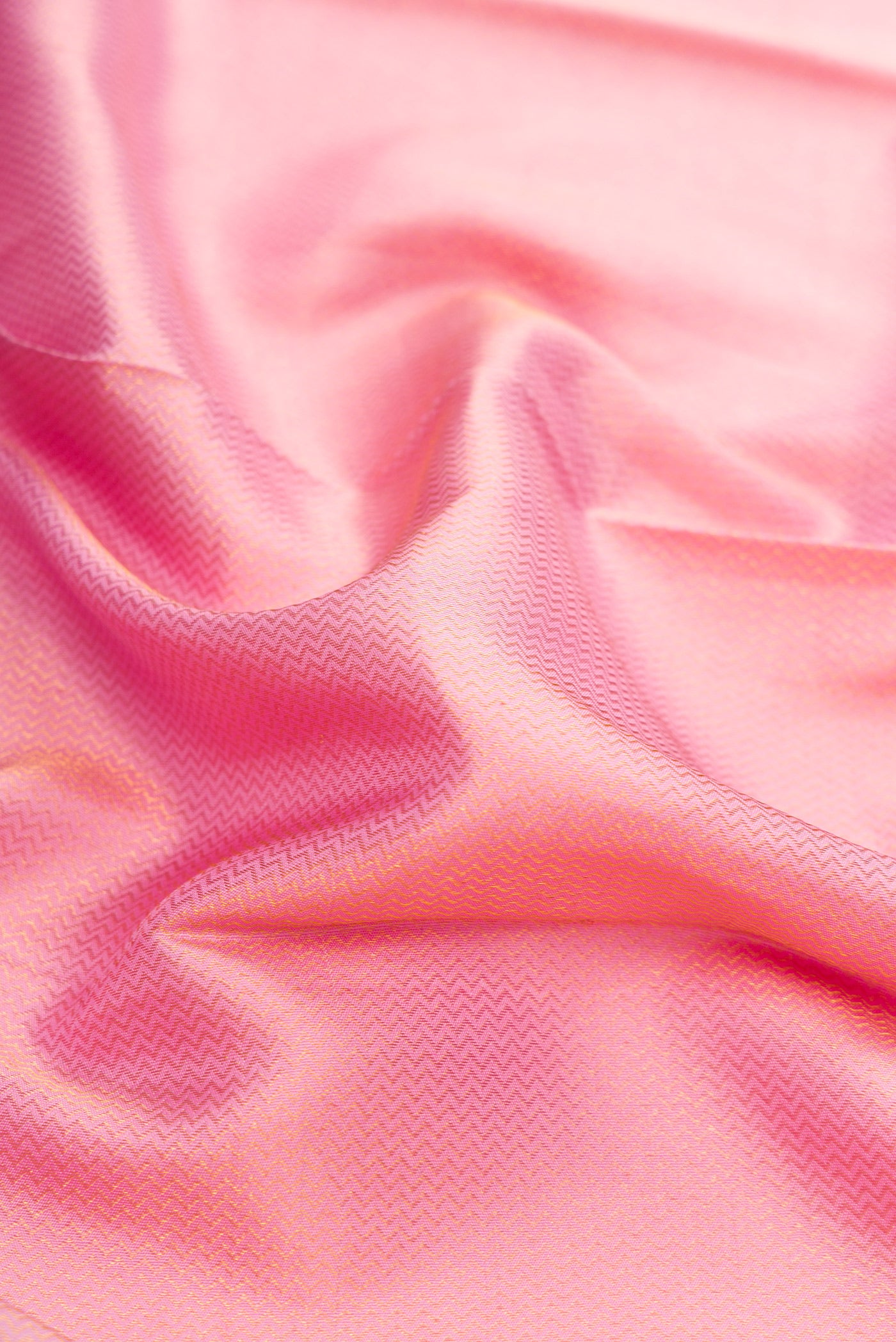 Close up of Pink Dual Tone Kanchipuram Silk Saree with Zari Brocade on the body and Zari Border.  displaying folds