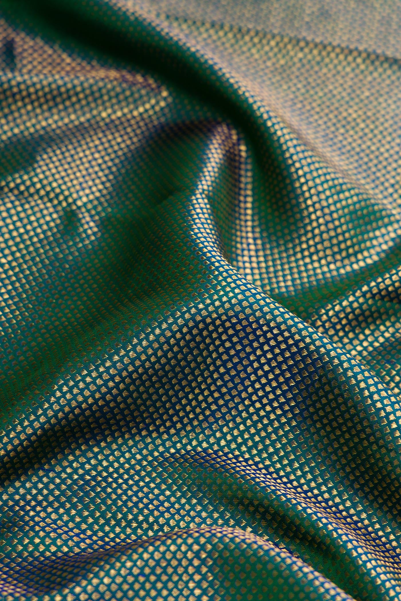 Close up of Peacock Blue Dual Tone Kanjivaram Silk Saree with Zari Brocade on the body and Zari Border.  displaying folds