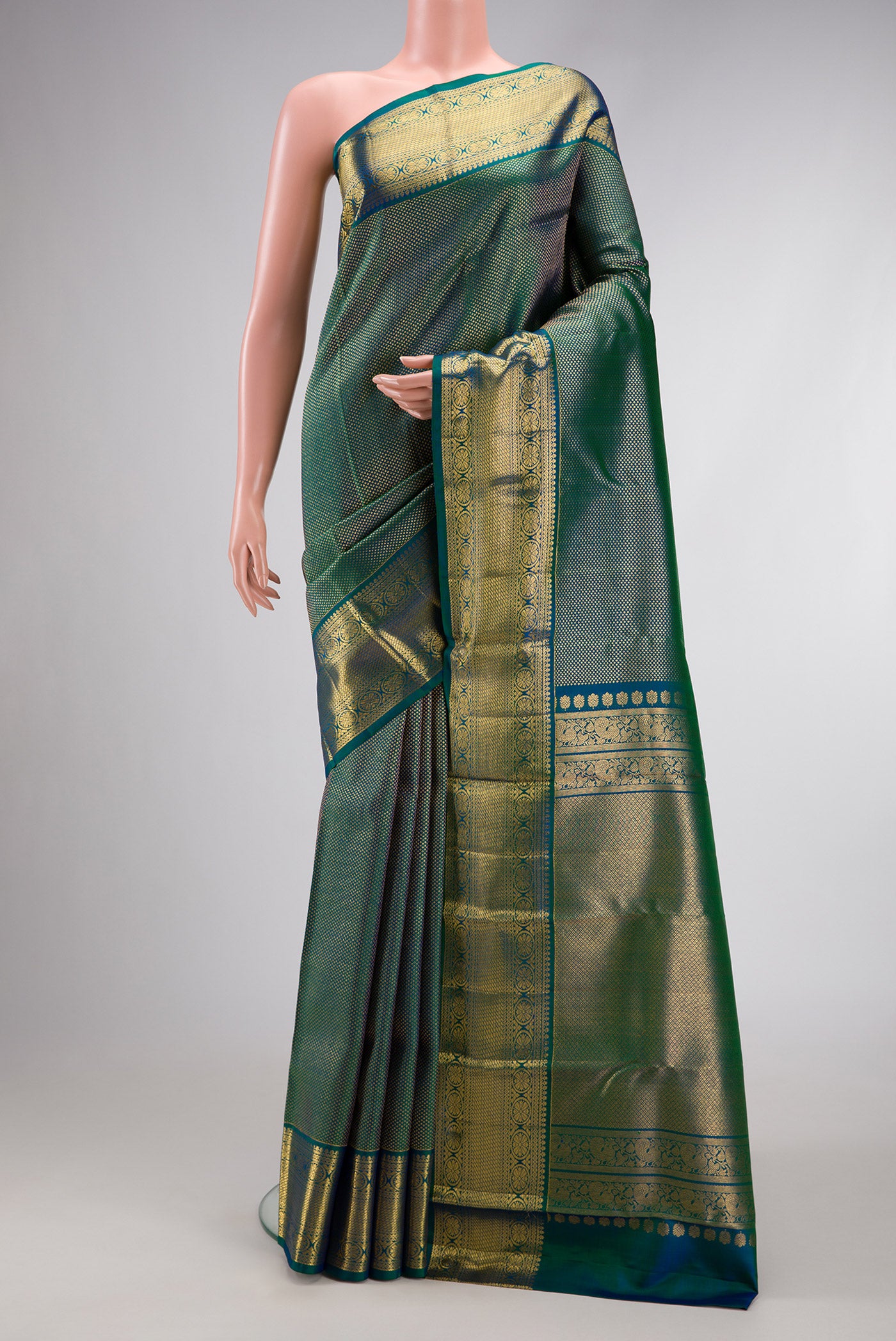 Peacock Blue Dual Tone Kanjivaram Silk Saree with Zari Brocade on the body and Zari Border.  displayed on a mannequin