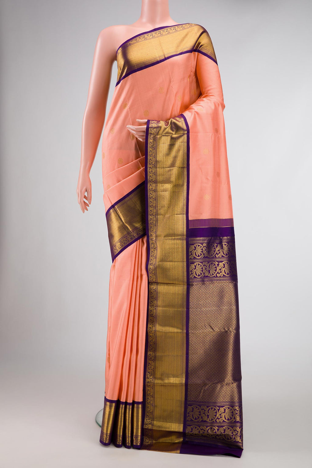 Peach Dual Tone Kanchipuram Silk Saree with Zari Butta on the body and Zari Border.  displayed on a mannequin
