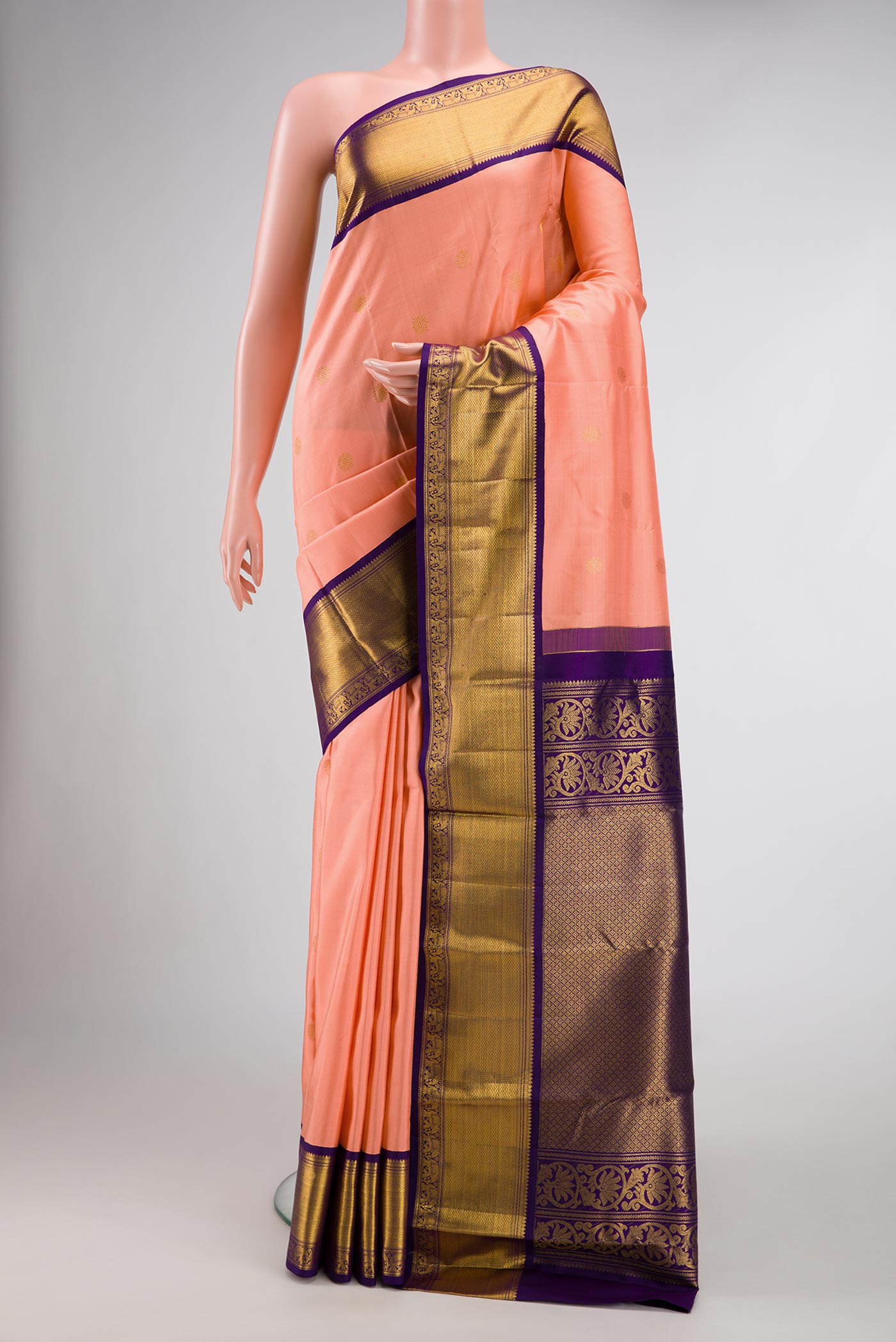 Peach Dual Tone Kanchipuram Silk Saree with Zari Butta on the body and Zari Border.  displayed on a mannequin
