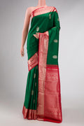 Green Dual Tone Kanchipuram Silk Saree with Zari Butta on the body and Zari Border displayed on a mannequin