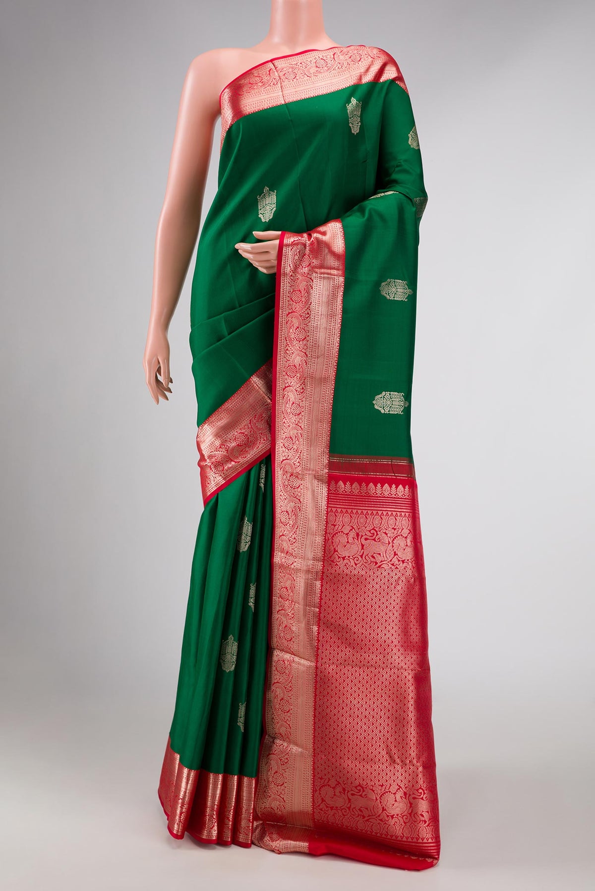 Green Dual Tone Kanchipuram Silk Saree with Zari Butta on the body and Zari Border displayed on a mannequin