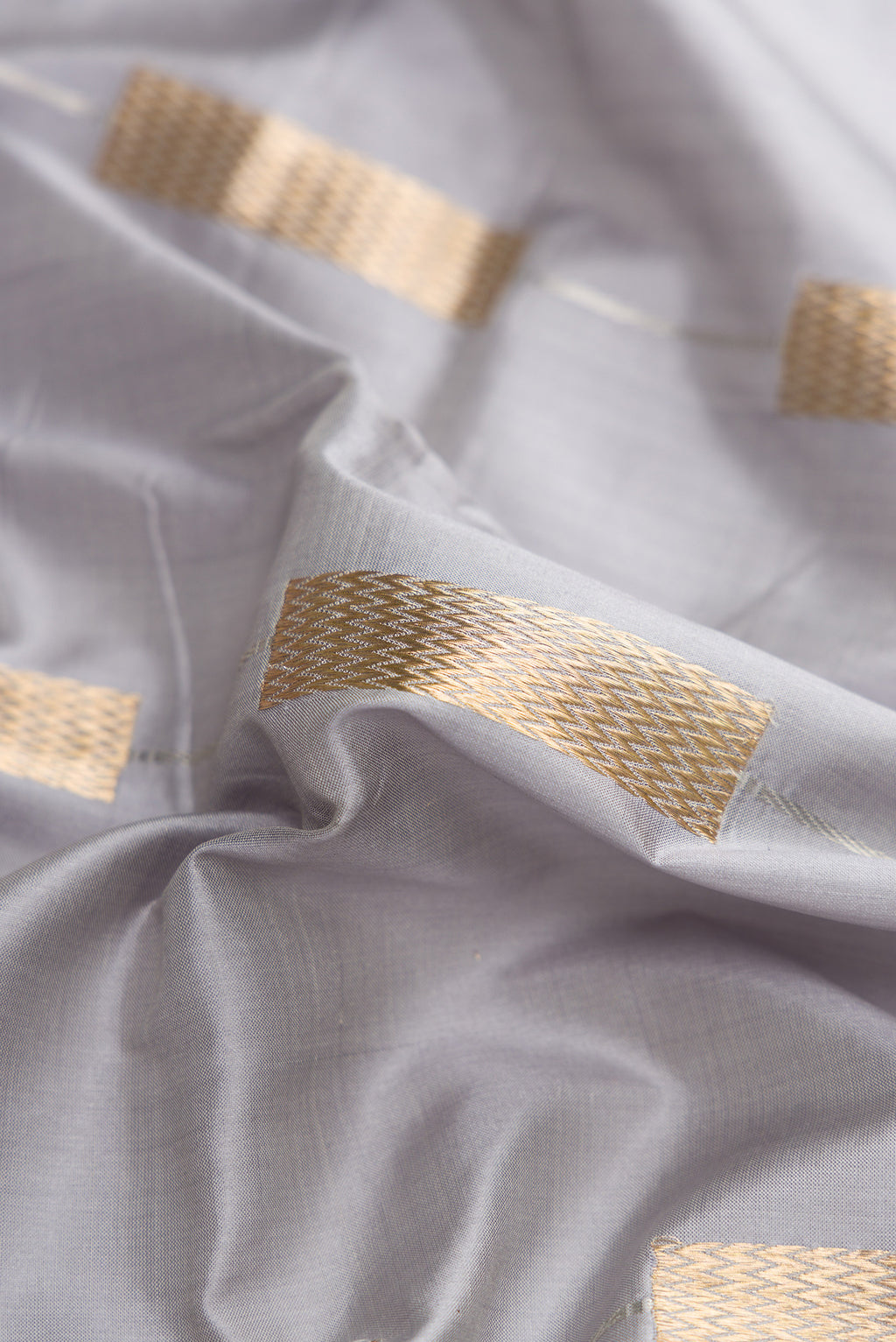 Close up of Grey Dual Tone Banarasi Silk Saree with Stripes on the body and Zari Border.  displaying folds