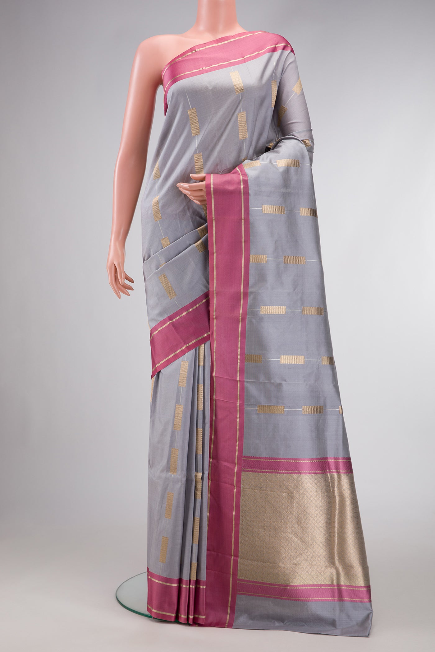 Grey Dual Tone Banarasi Silk Saree with Stripes on the body and Zari Border.  displayed on a mannequin