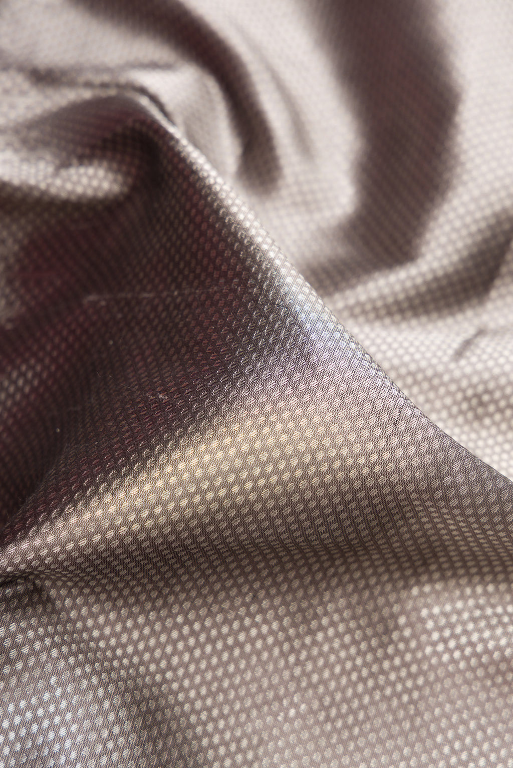 Close up of Grey Dual Tone Banarasi Silk Saree with Zari Brocade on the body and Zari Border.  displaying folds