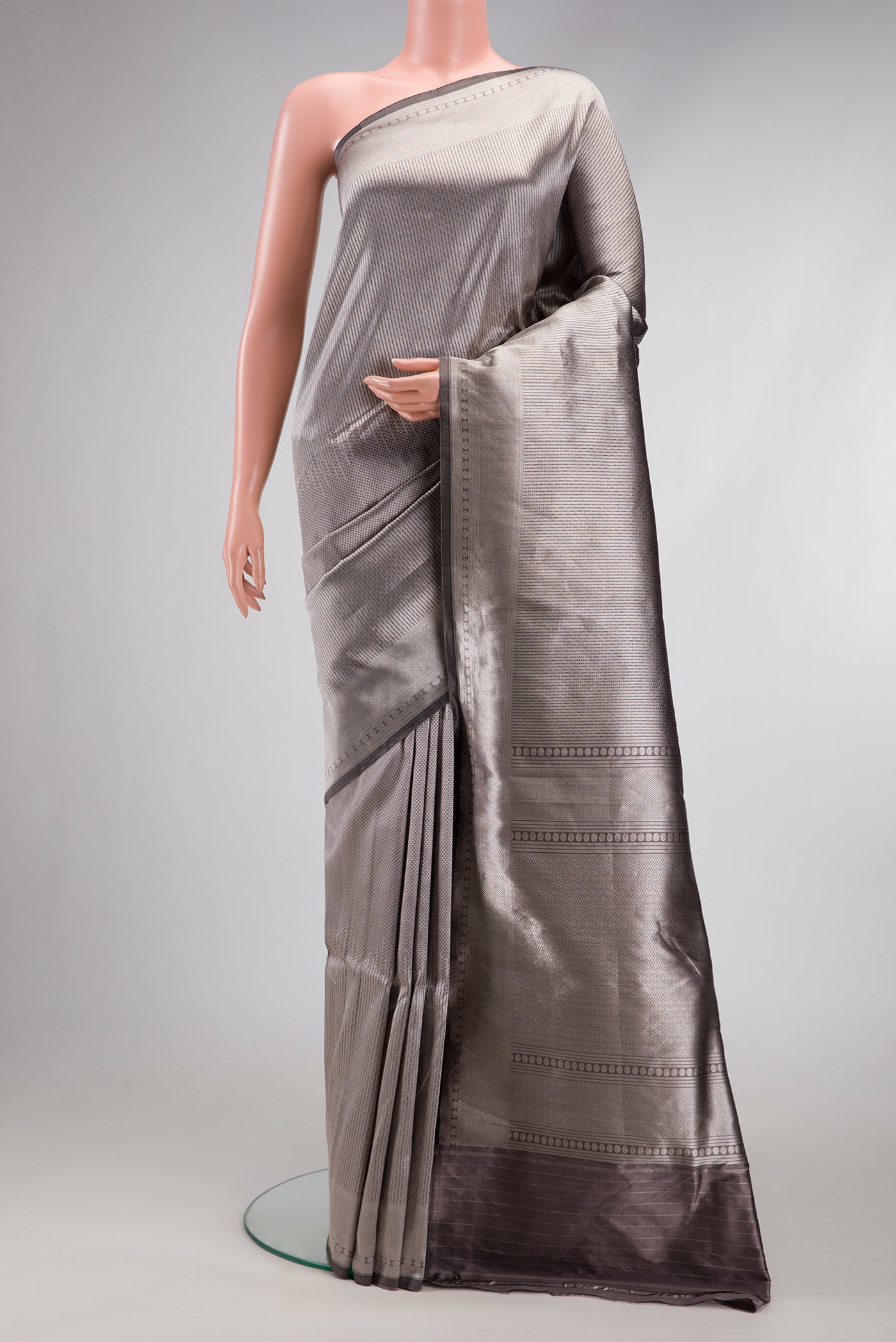 Grey Dual Tone Banarasi Silk Saree with Zari Brocade on the body and Zari Border.  displayed on a mannequin