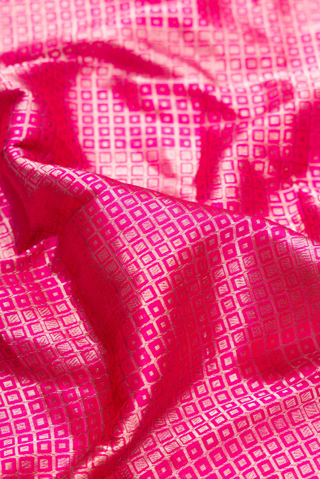 Close up of Pink Dual Tone Banarasi Silk Saree with Zari Brocade on the body and Zari Border.  displaying folds