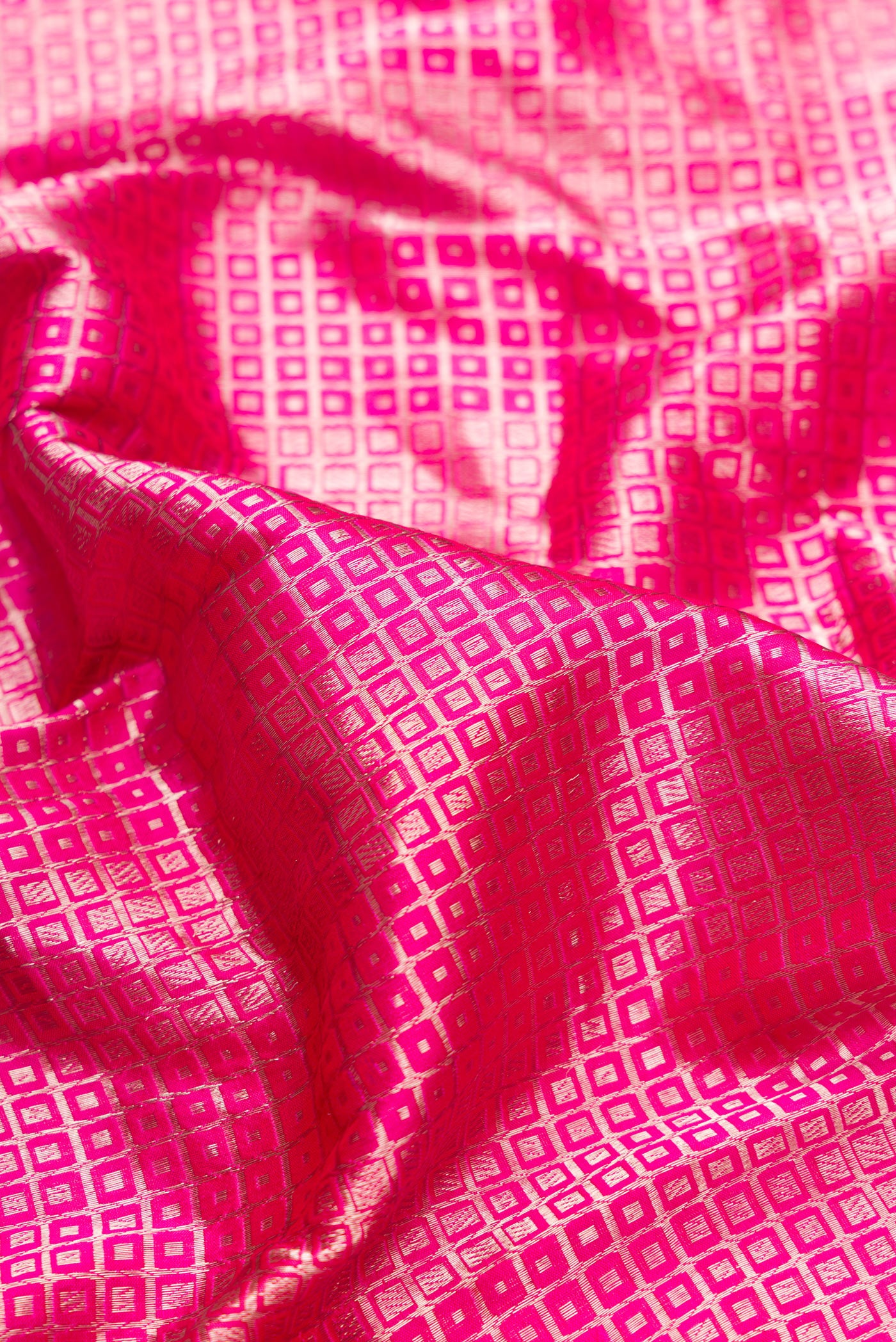 Close up of Pink Dual Tone Banarasi Silk Saree with Zari Brocade on the body and Zari Border.  displaying folds