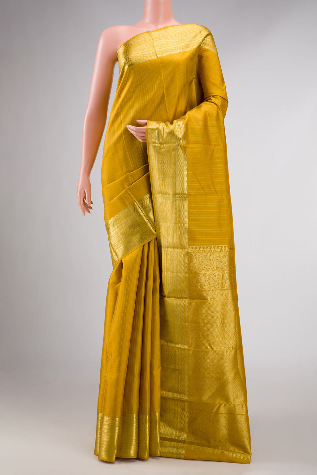 Mustard Dual Tone Kanchipuram Silk Saree with Zari Butta on the body and Zari Border displayed on a mannequin