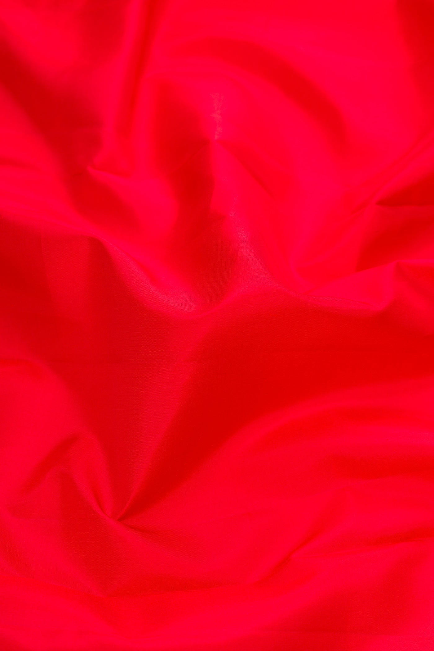 Close up of Red Dual Tone Kanjivaram Silk Nine Yards Saree with Plain Body and Zari Border.  displaying folds