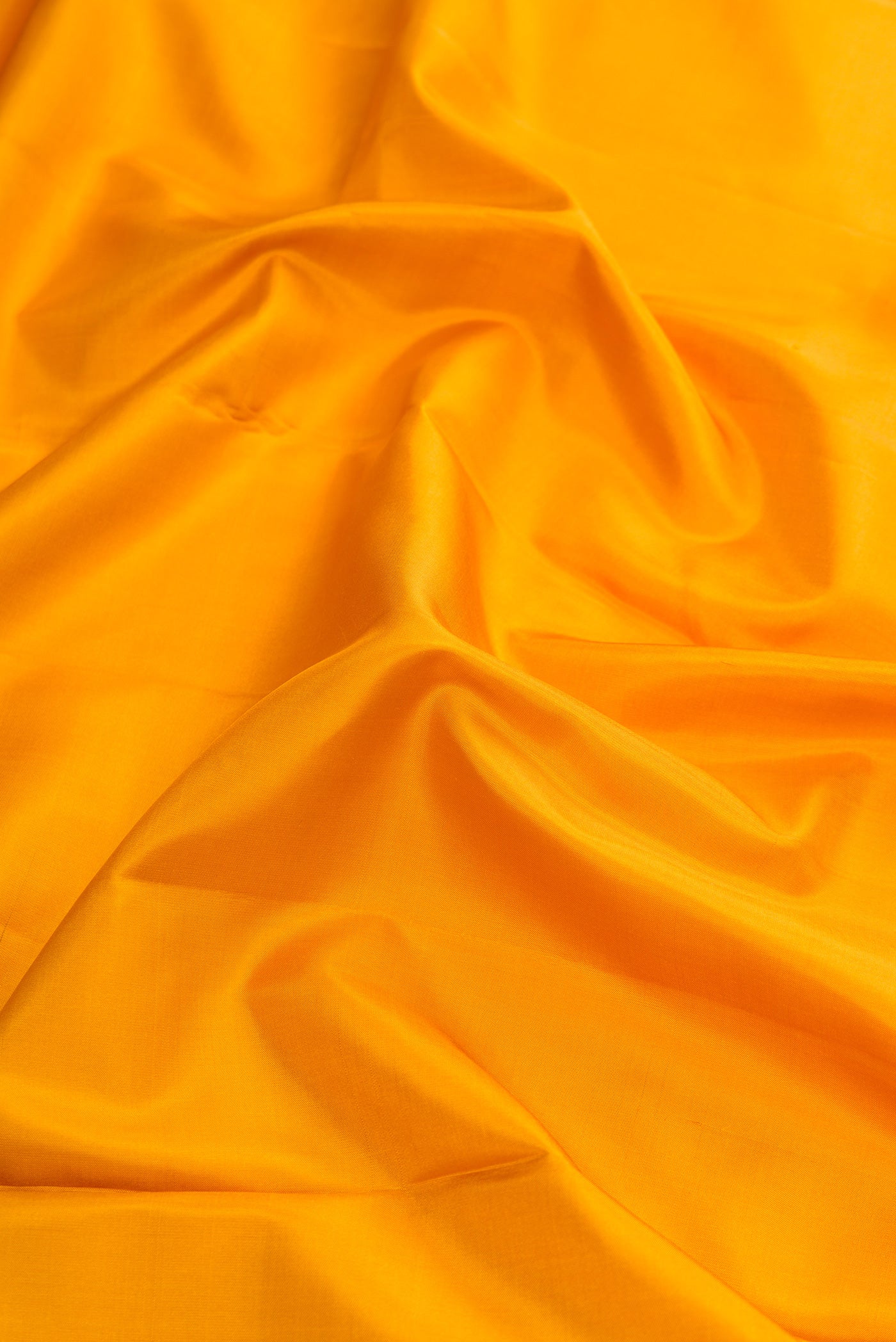 Close up of Mustard Dual Tone Kanjivaram Silk Nine Yards Saree with Plain Body and Zari Border.  displaying folds