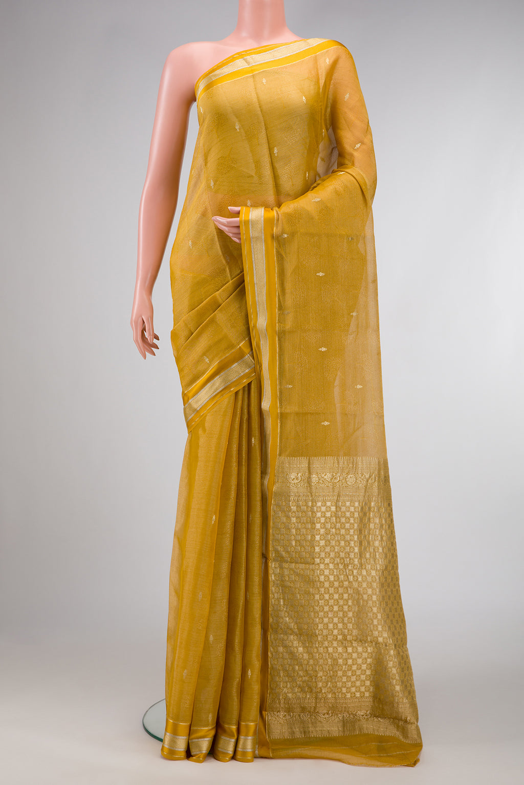 Mustard Dual Tone Mysore Georgette Saree with Zari Brocade on the body and Zari Border.  displayed on a mannequin