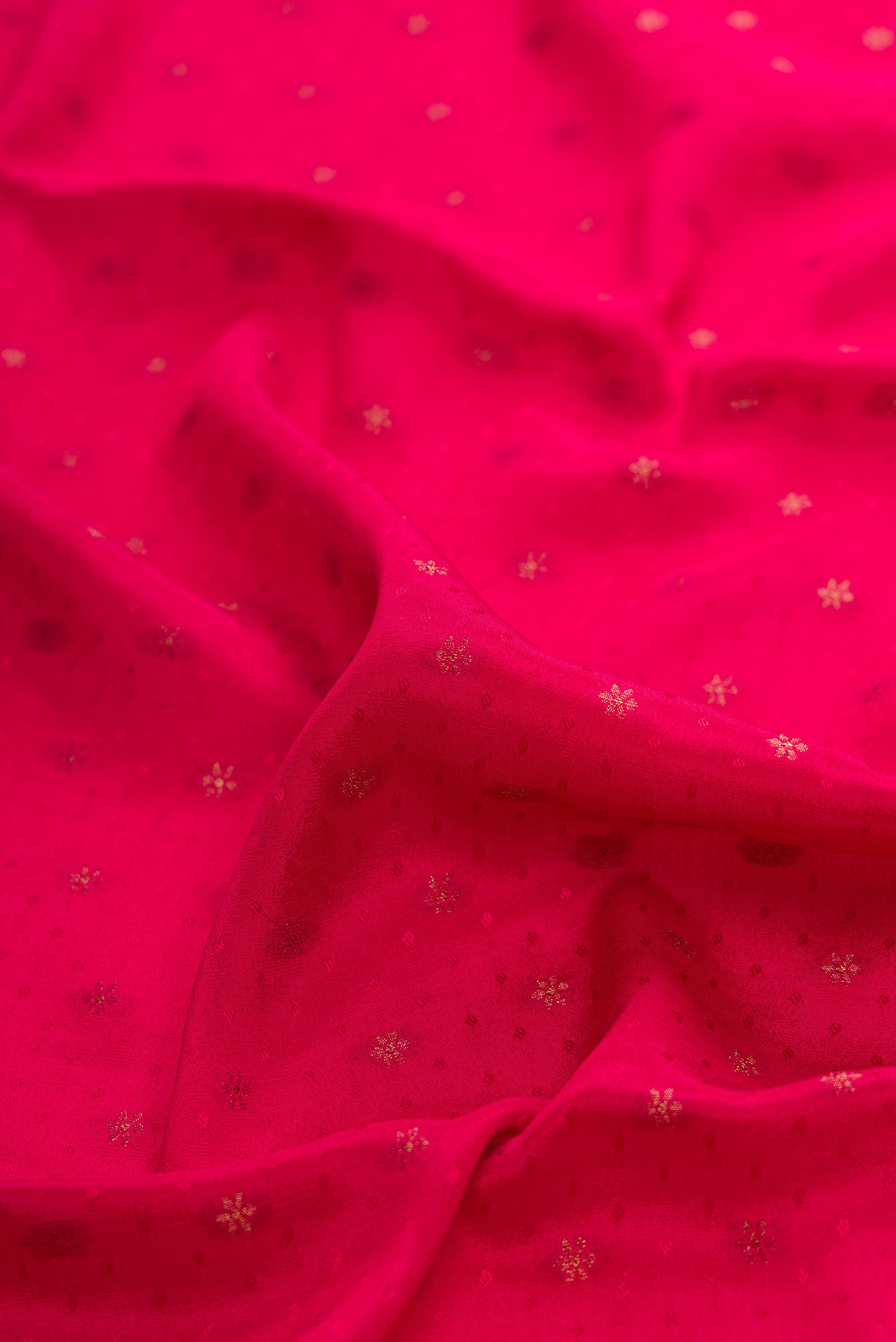 Close up of Dark Pink Dual Tone Banarasi Georgette Saree with Jacquard With Zari Butta on the body and Zari Border.  displaying folds