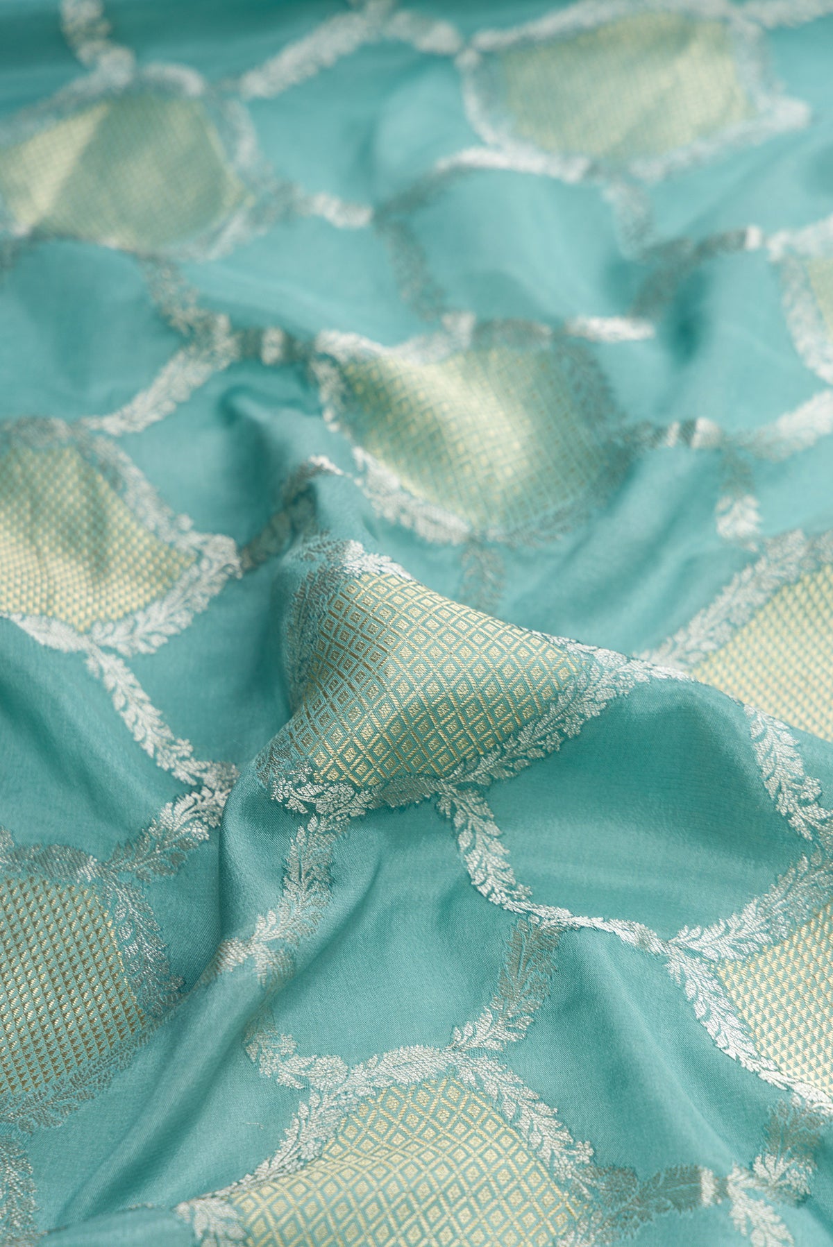 Close up of Maya Blue Dual Tone Mysore Georgette Saree with Zari Brocade on the body and Zari Border.  displaying folds