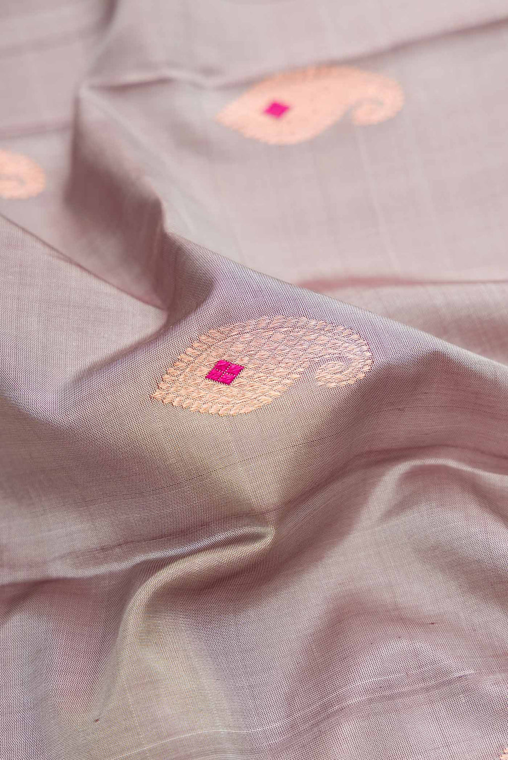 Close up of Grey Dual Tone Kanjivaram Silk Saree with Zari Butta on the body and Zari Border.  displaying folds