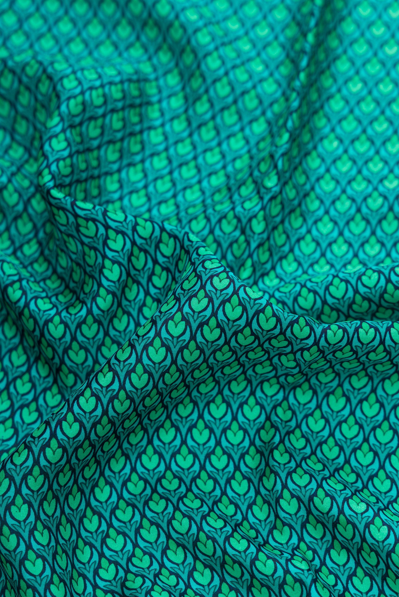 Close up of Sea Green Dual Tone Printed Silk Saree with Printed design on the body and Printed Border.  displaying folds
