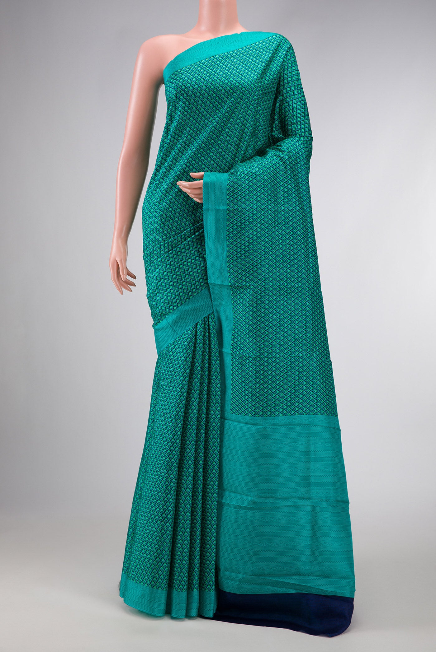 Sea Green Dual Tone Printed Silk Saree with Printed design on the body and Printed Border.  displayed on a mannequin