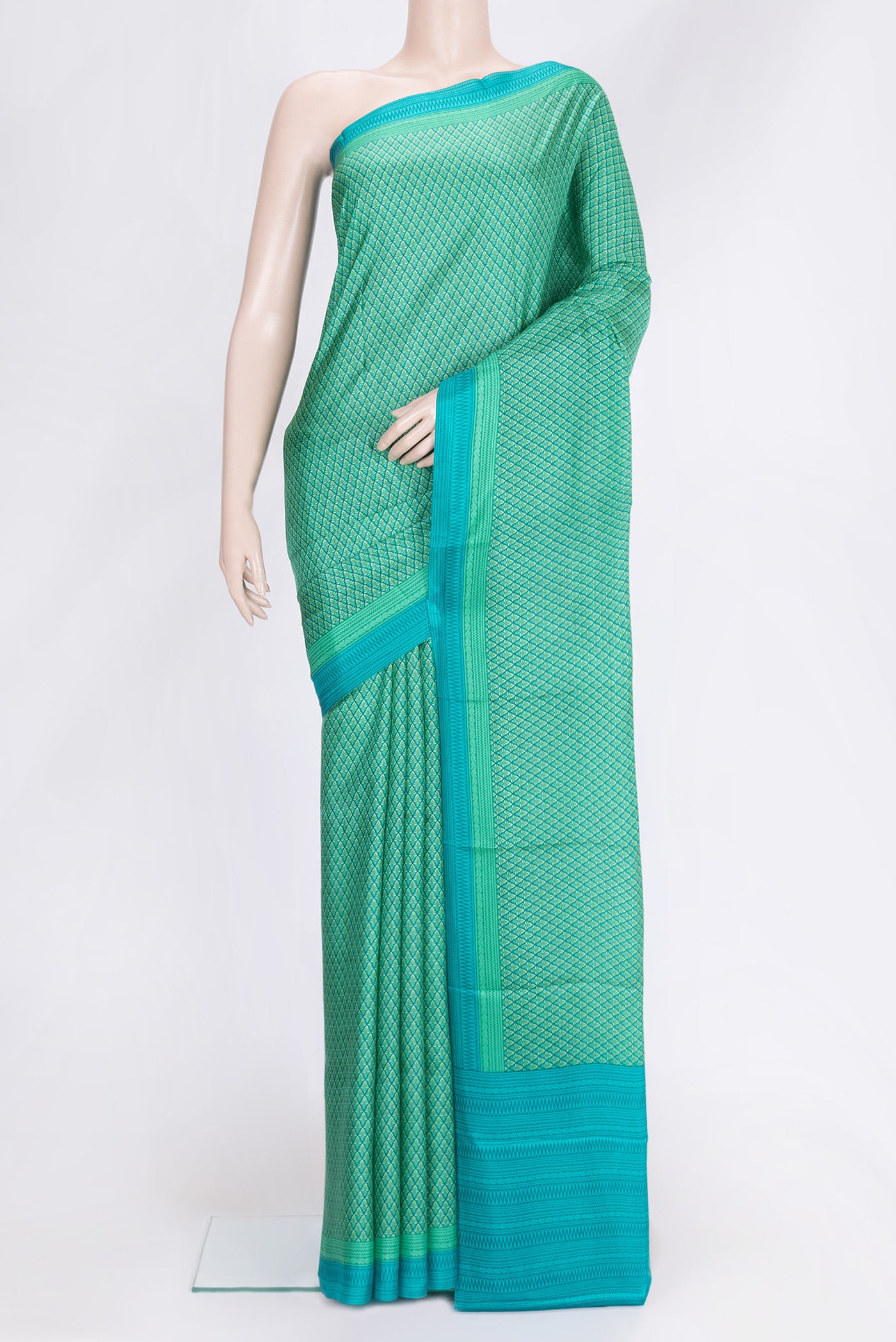 Sea Green Dual Tone Printed Silk Saree with Printed design on the body and Printed Border.  displayed on a mannequin