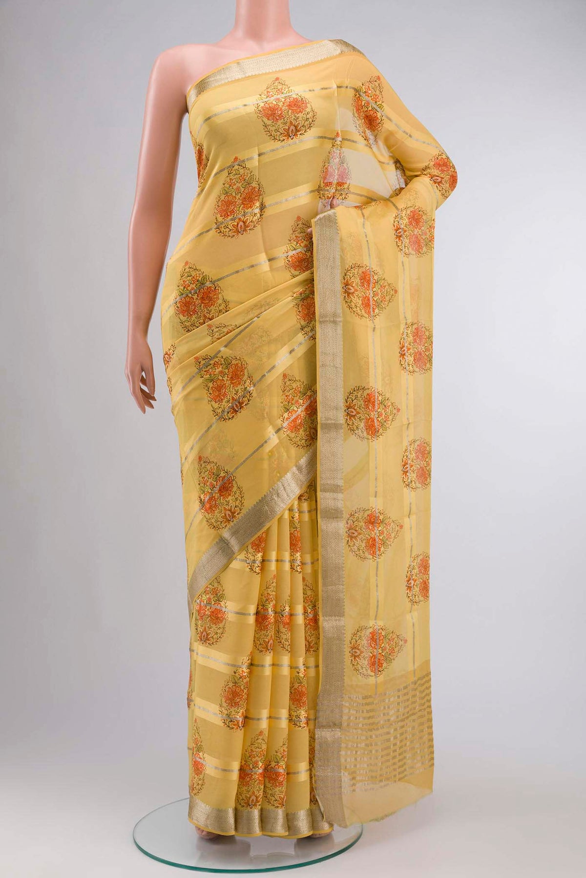 Yellow Mysore Georgette Saree Printed design on the body and Zari Border displayed on a mannequin