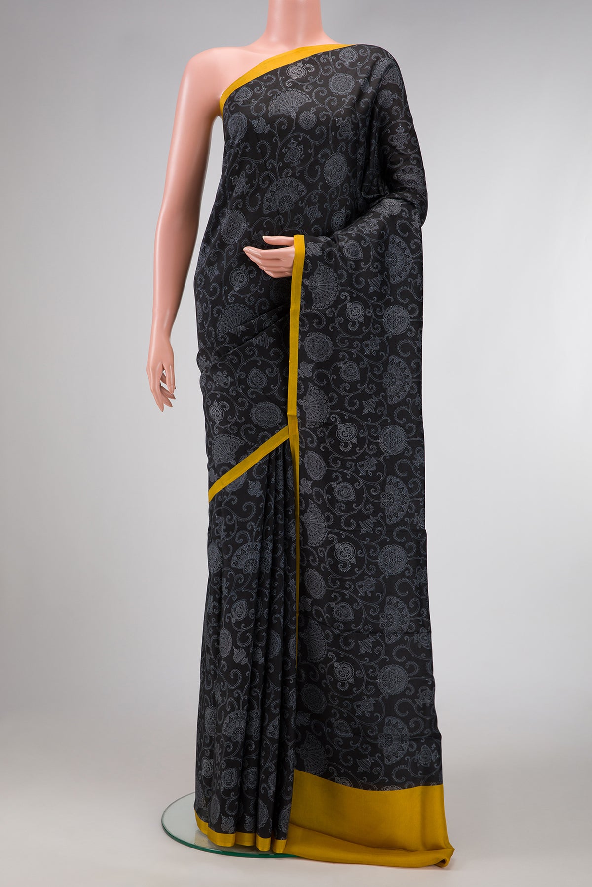 Black Dual Tone Printed Silk Saree with Printed design on the body and Plain Border.  displayed on a mannequin