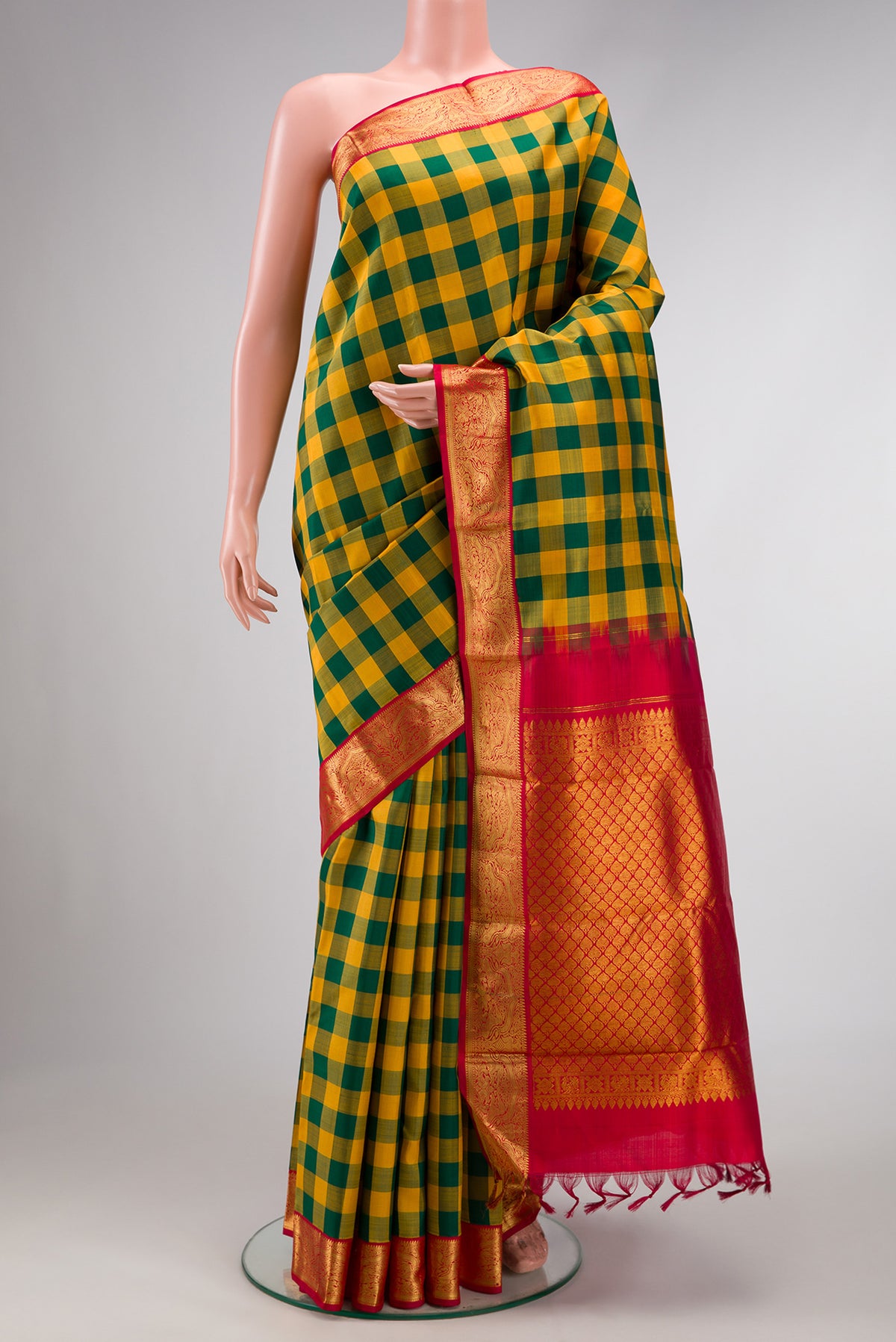 Pure Silk Pure Zari Green and Mustard Color Kanjivaram Saree with Checked design on the body and Zari Border.  displayed on a mannequin