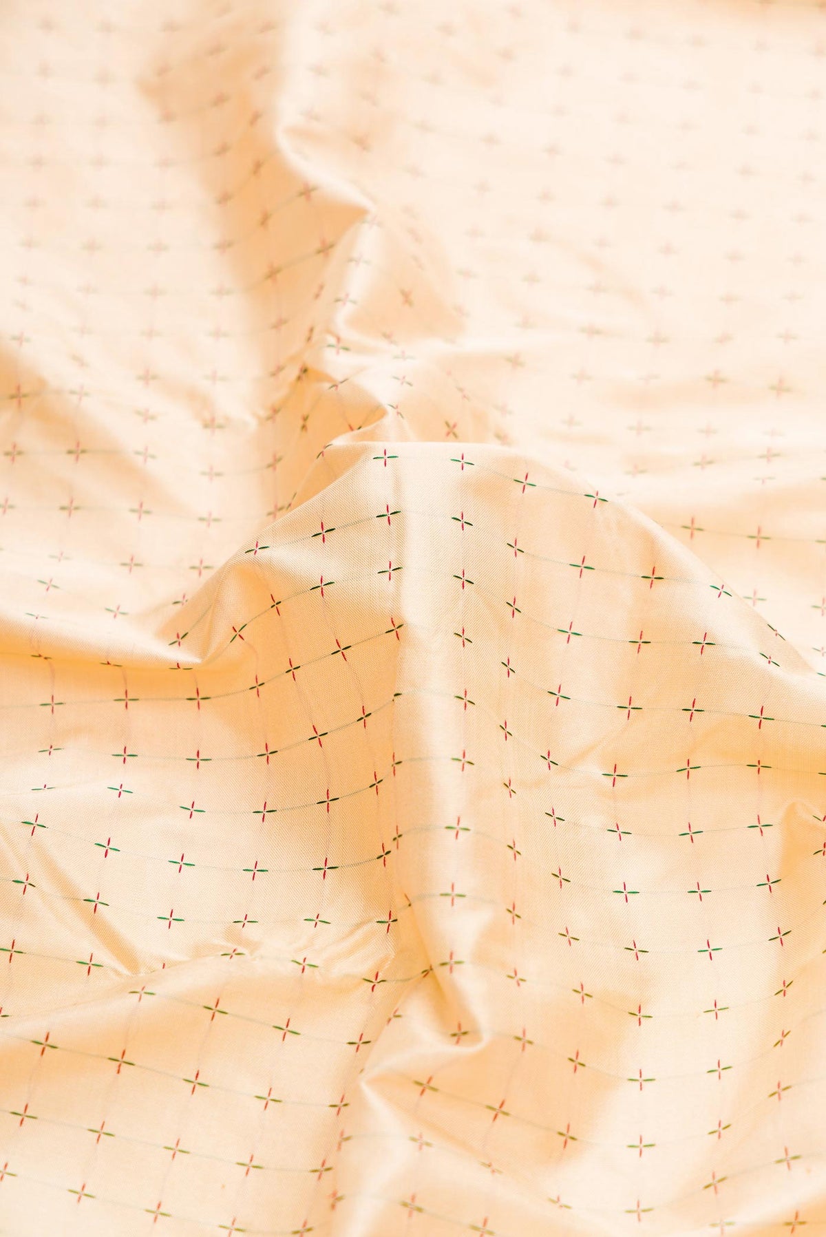 Close up of Pure Silk Pure Zari Beige Dual Tone Kanchipuram Saree with Thread Butta on the body and Ganga Jamuna Border displaying folds